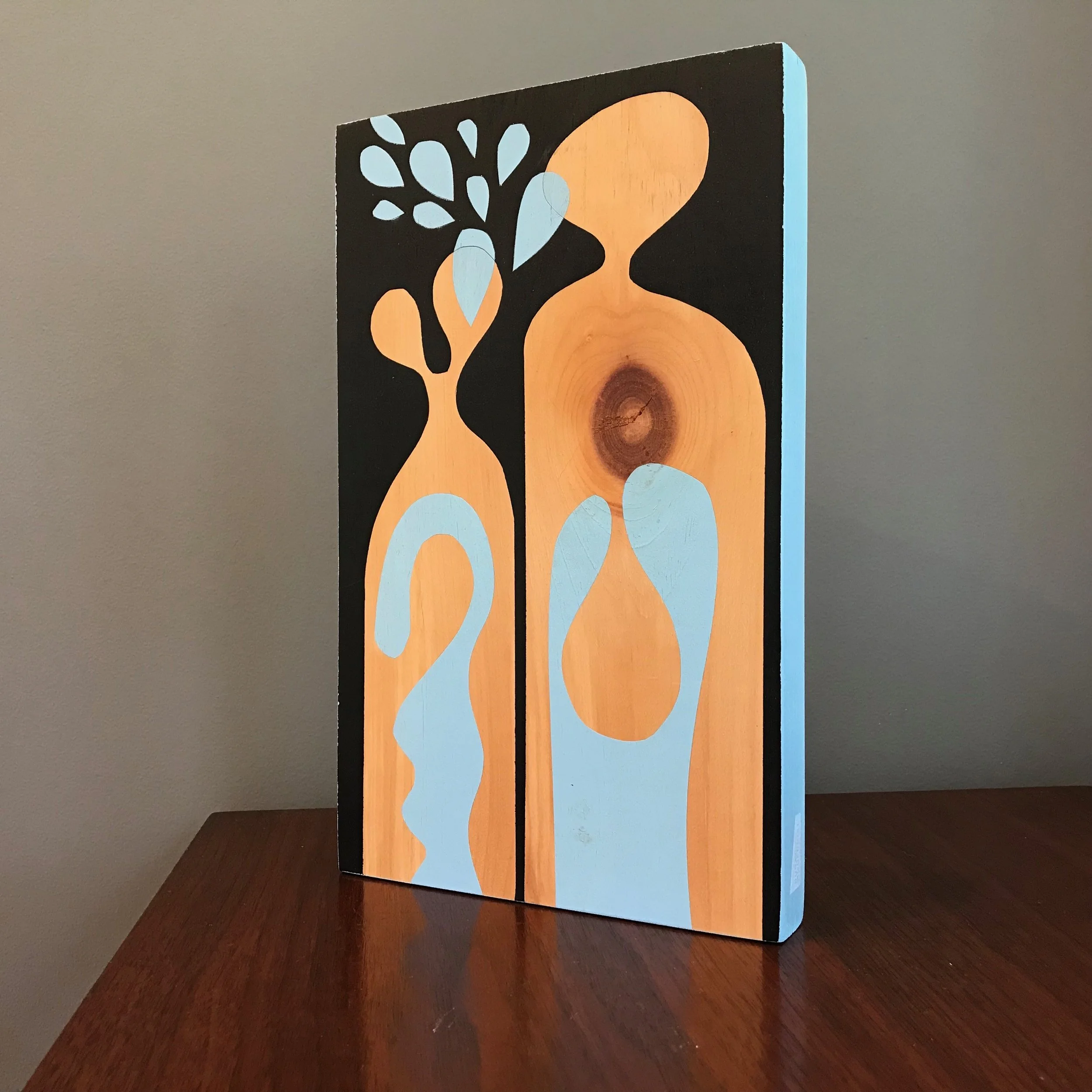 large painting with black and baby blue shapes with baby blue edge