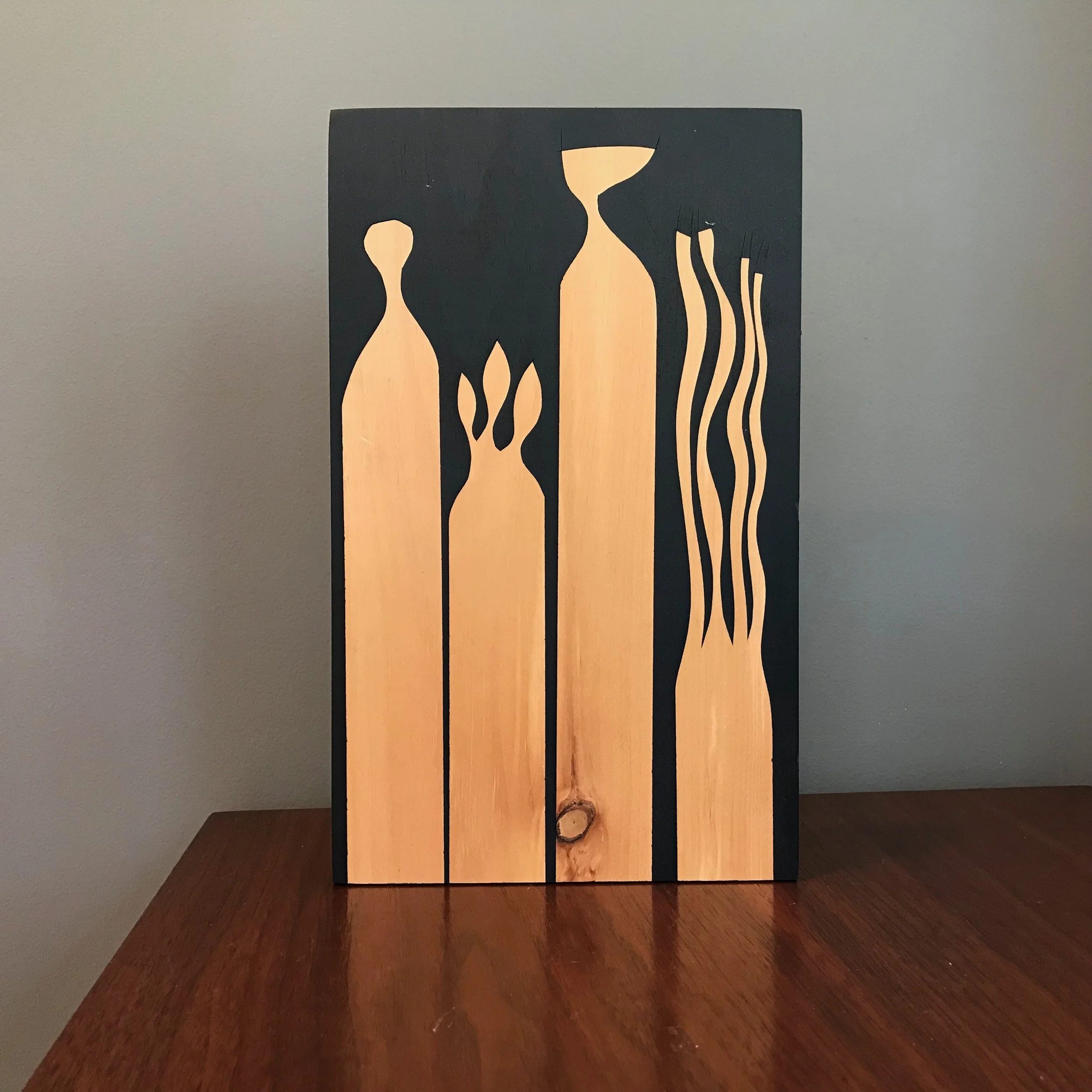 large painting with organic silhouettes on black background