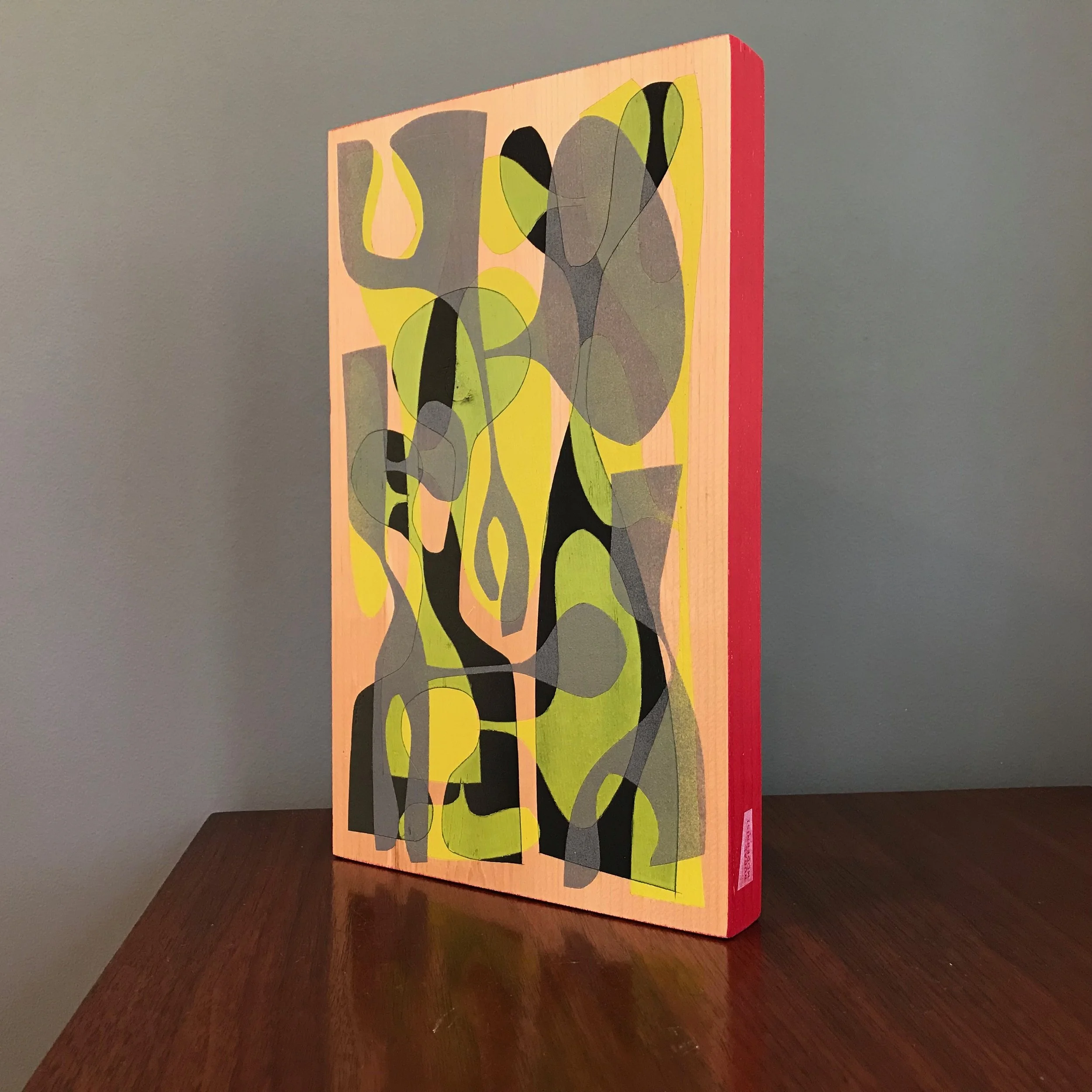 large painting with gray, black, and neon yellow shapes with rocket red edge