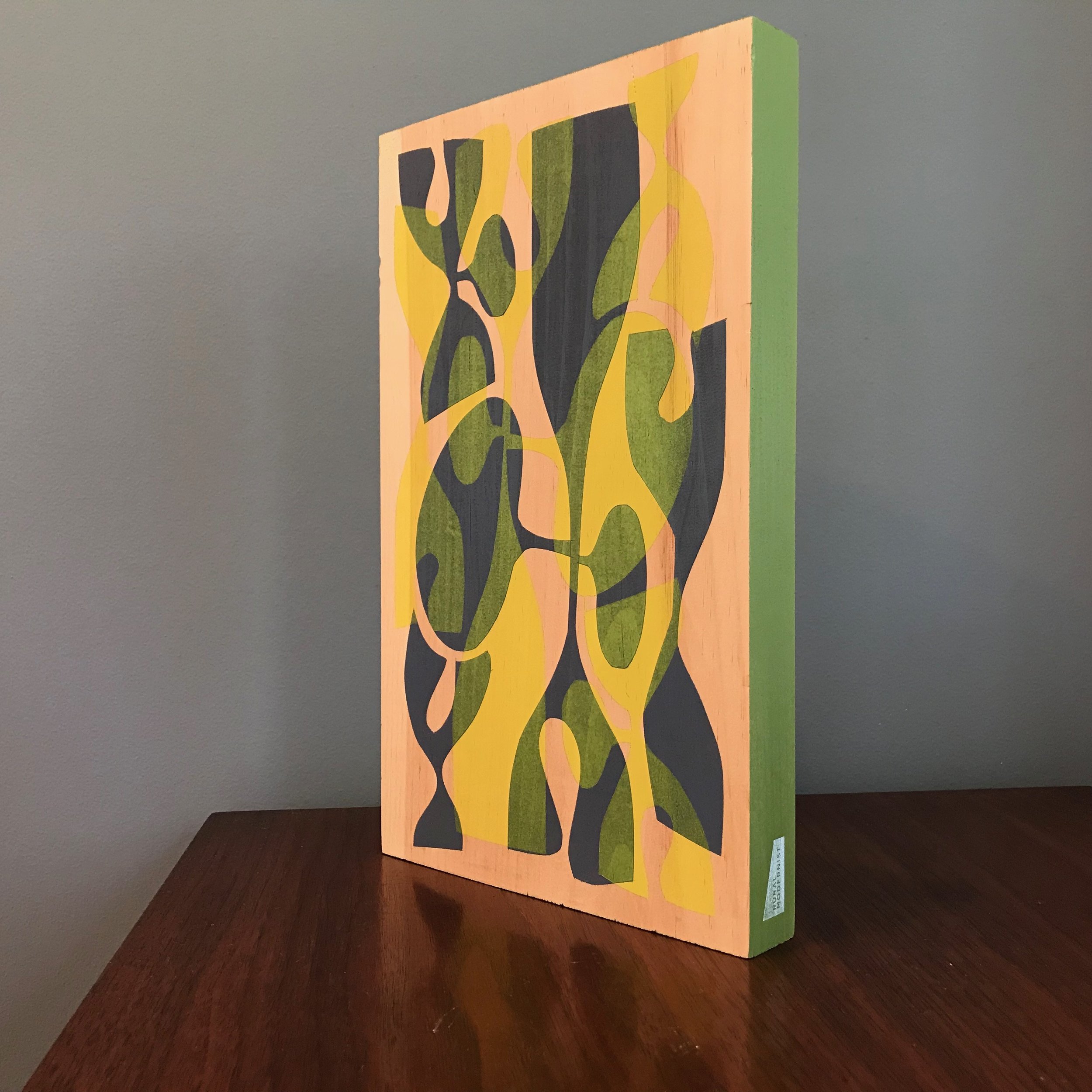 large painting with black and neon yellow shapes and olive green edge