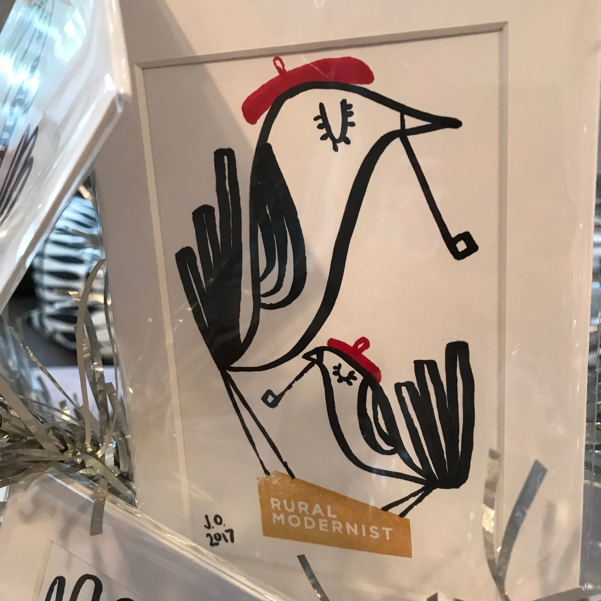 two birds with red berets smoking pipes