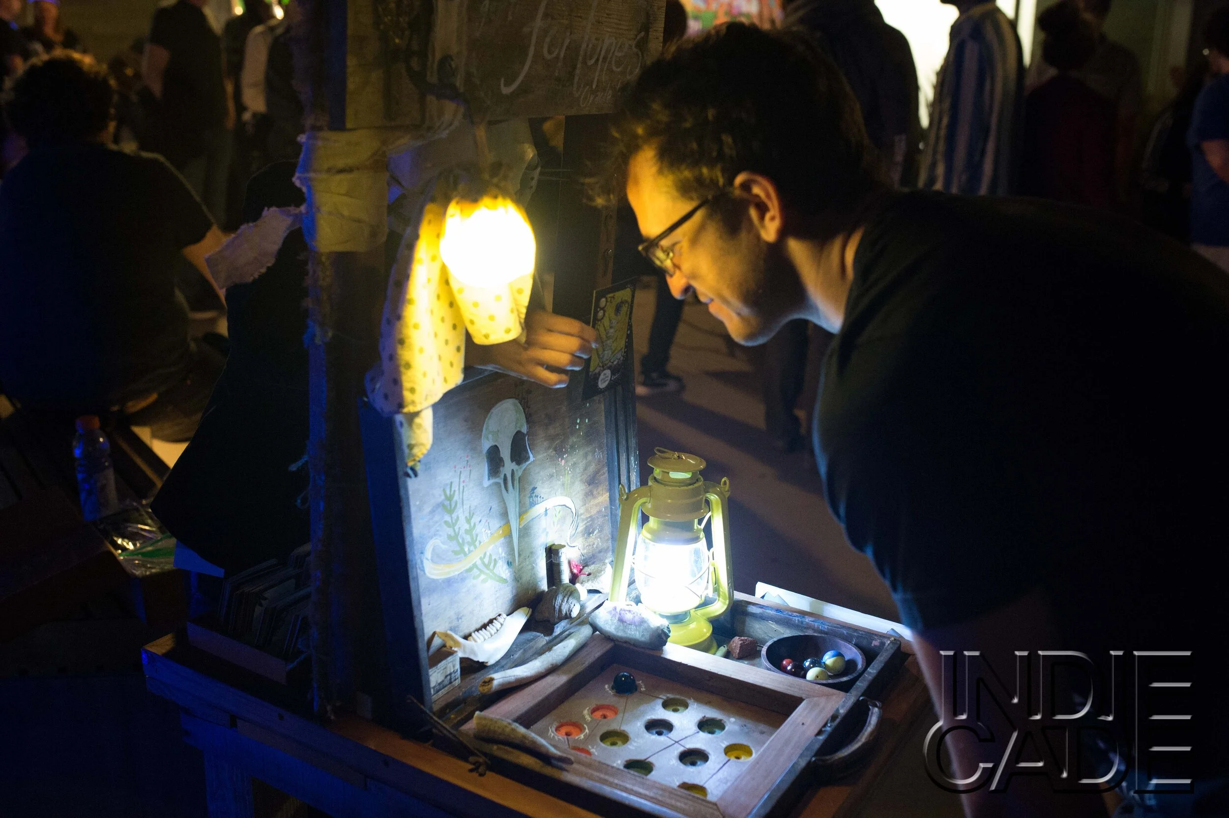  Participants were asked to hold a question in their head, and select a sphere of their choice(an assortment of marbles and small balls) and toss it into the divination board. The hole that the ball fell into would correspond with the fortune they we