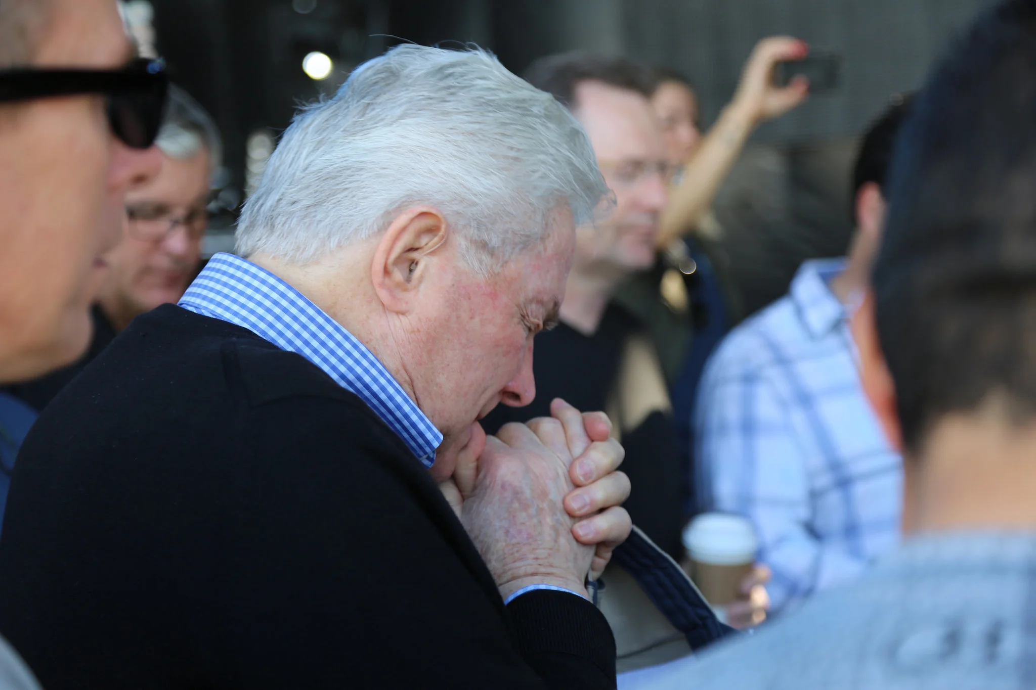 Luis praying with other pastors and leaders in preparation for a festival.