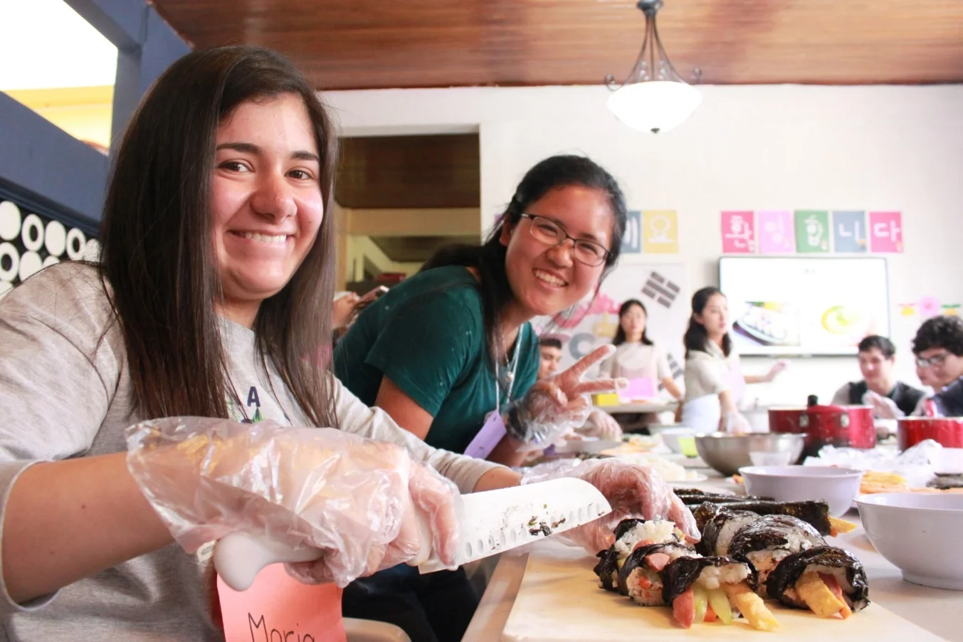 Fuyu, and one of her guests, Maria, make kimbap for lunch at the Korean Culture Event on Friday!