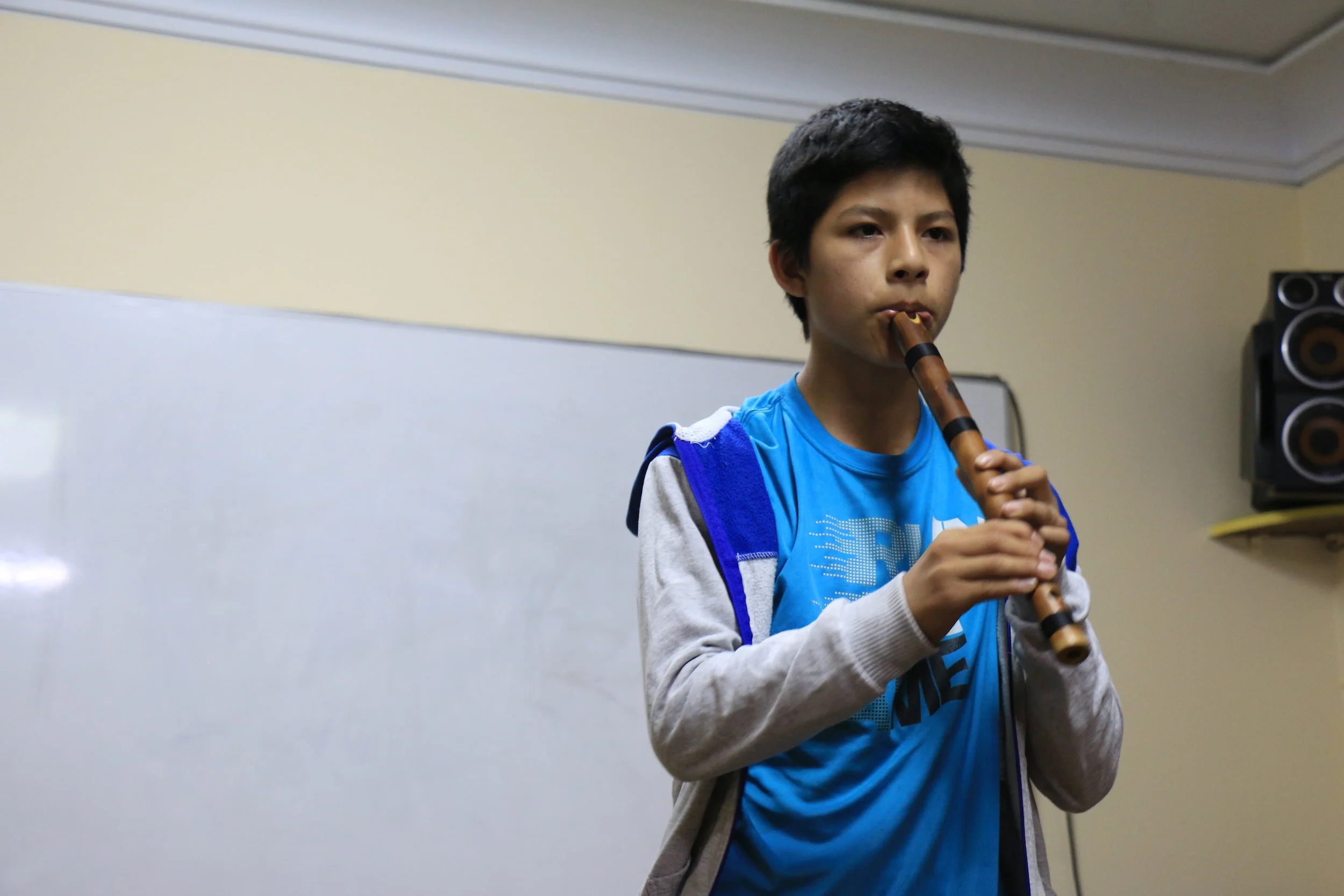 High School Participant Playing a Traditional Peruvian Recorder