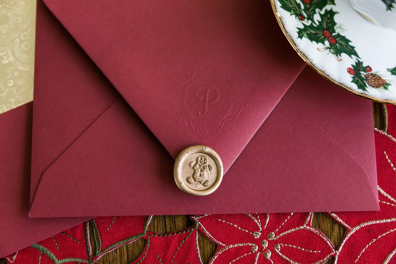 Embossed initial and a gingerbread man wax seal.