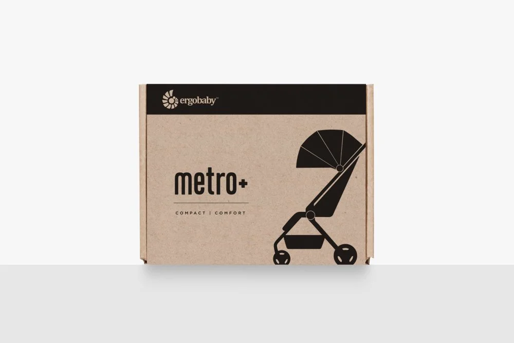 A cardboard box with the brand hello egg and black and beige design, labeled 'metro+', and an illustration of a baby stroller.