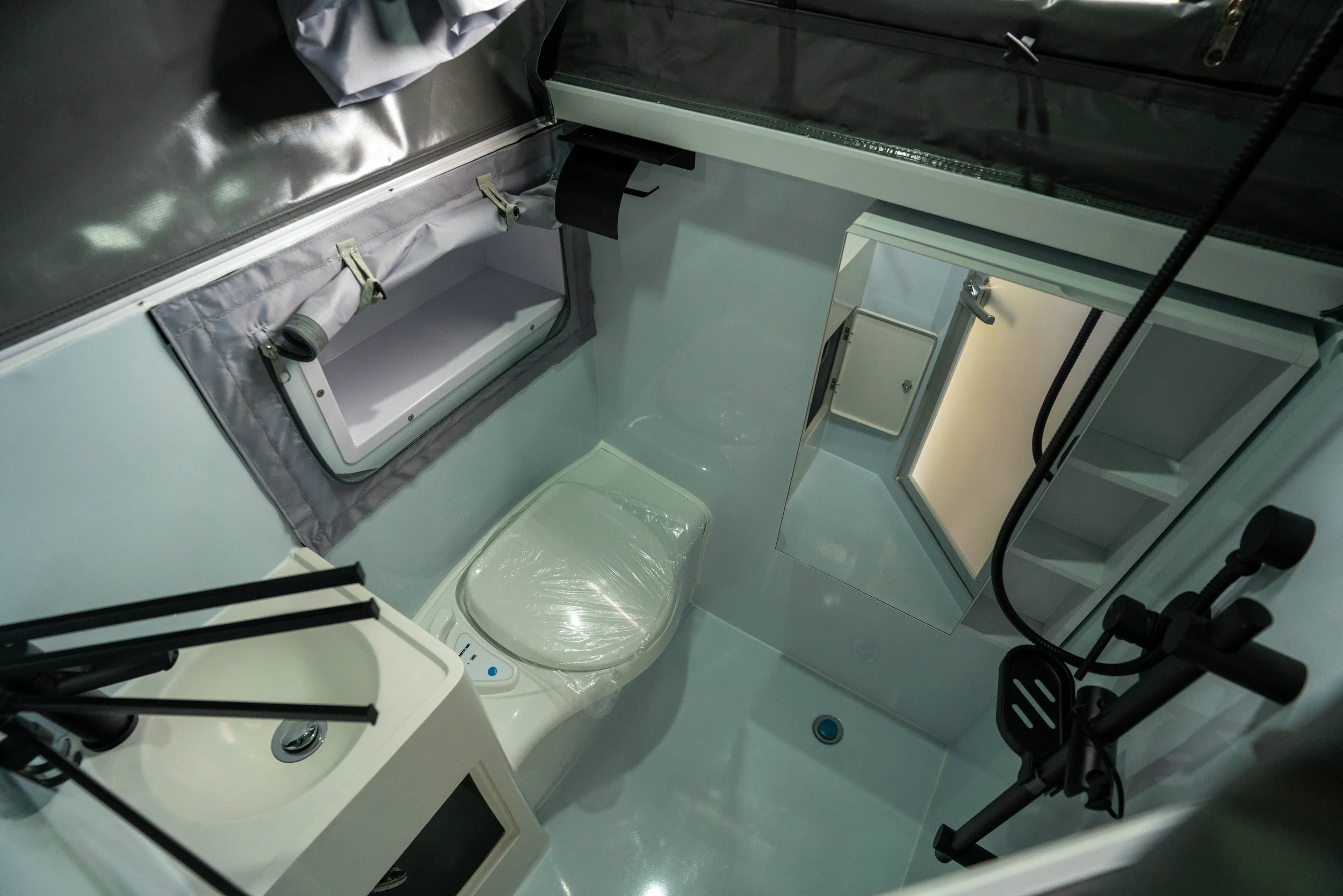 The interior of a space habitat or research module with a hatch, storage area, and equipment, likely on a spacecraft or space station.