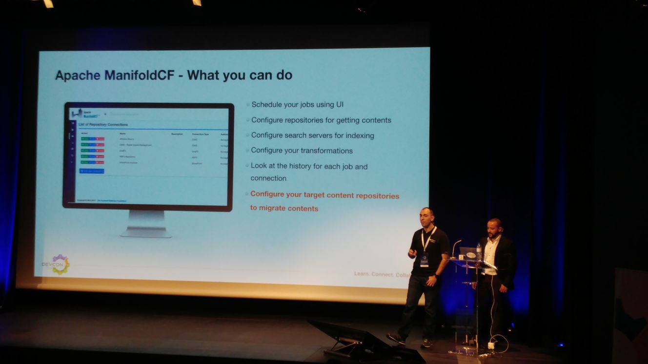 PJ with Luis on the stage talking about Content Migration