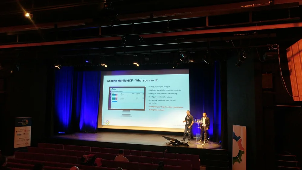 PJ with Luis on the stage talking about Content Migration