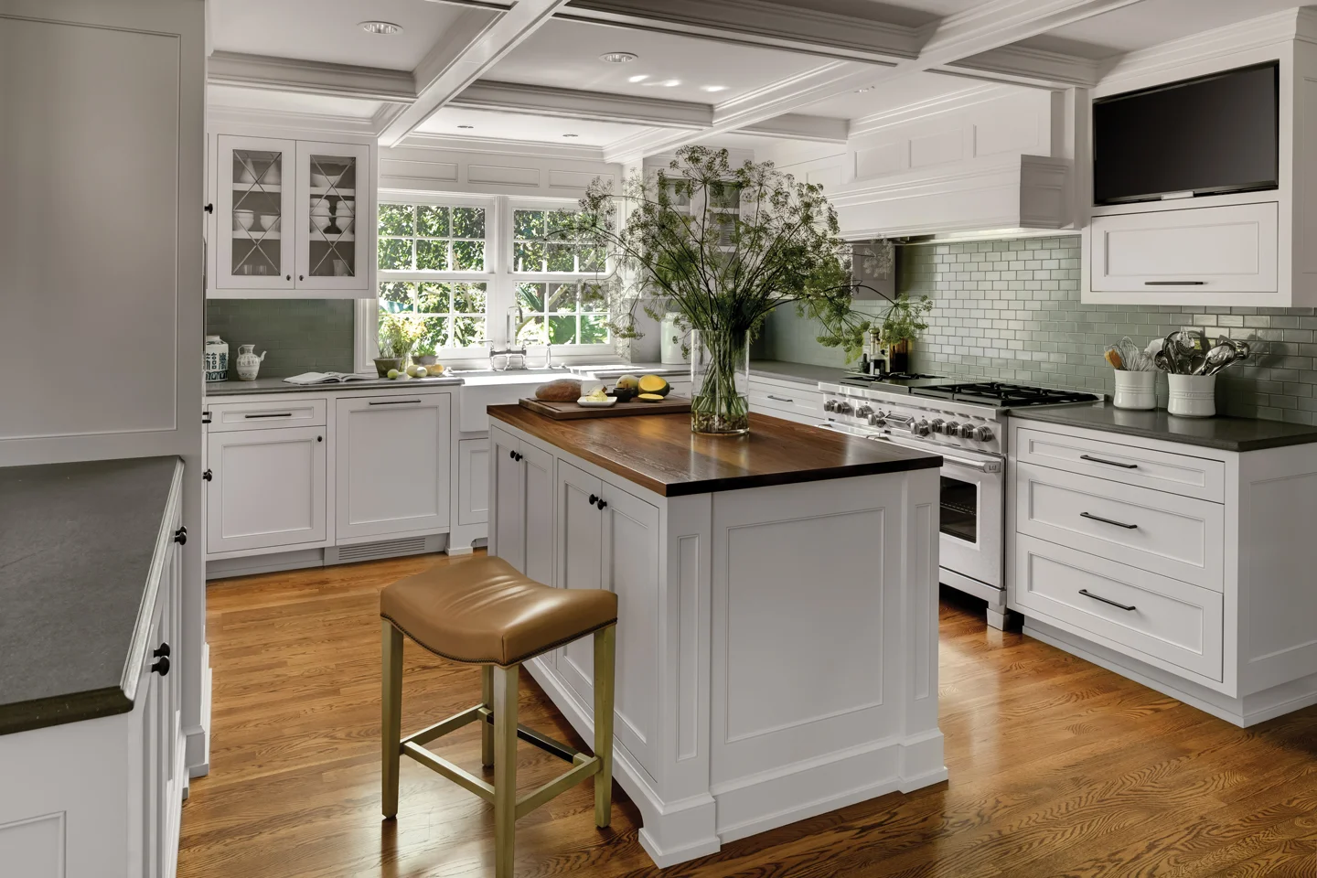 “This kitchen was a challenge because the space is not large, and the clients are avid cooks. The layout was complex to accommodate everything they wanted: two dishwashers, full-height wine cooler, 48” fridge, professional-grade range, freezer drawers, warming drawer, built-in expresso machine, flat screen, and all the storage. In addition, this was the dark side of the house, and we wanted to maximize what light was there. The box beams added some visual volume to the room.” What clients request most: generous islands and high quality appliances. There is always a balance to strike between durability offered by manufactured options and the beauty and “soul" of living materials.