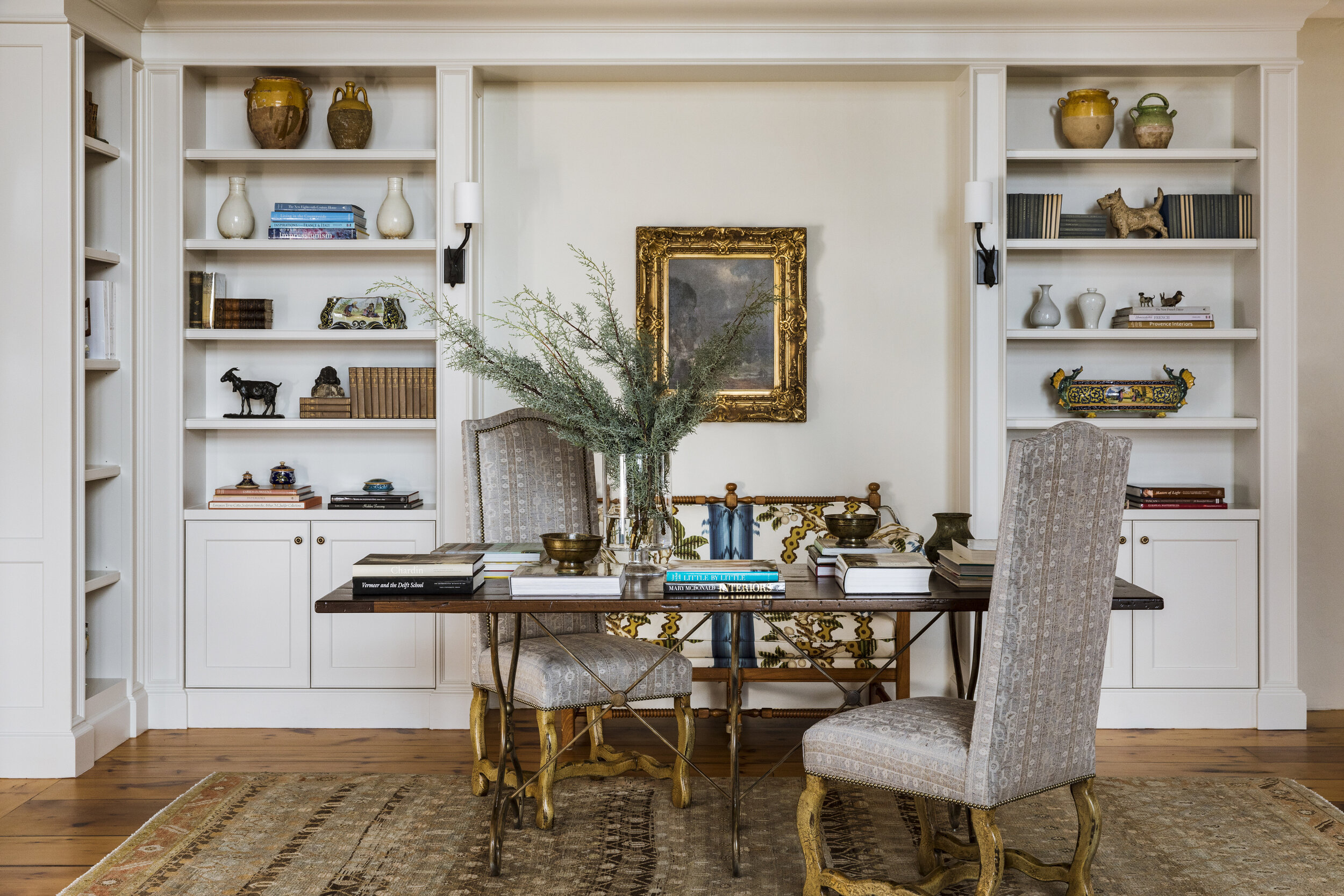  Custom built-ins define the library. Nesen covered the antique chairs in a Jasper linen blend and reupholstered her settee in a Brunschwig &amp; Fils print, both in keeping with the traditional feel of the furnishings. Complementing the arrangement 