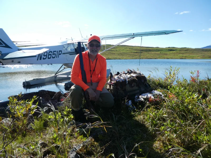 Me with a limit of birds in front of the Super Cub. The cover in the background shows some of the easiest walking you could ask for in ptarmigan hunting.