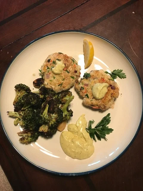 Halibut cakes with garlic-dill aioli and a side of roasted broccoli.
