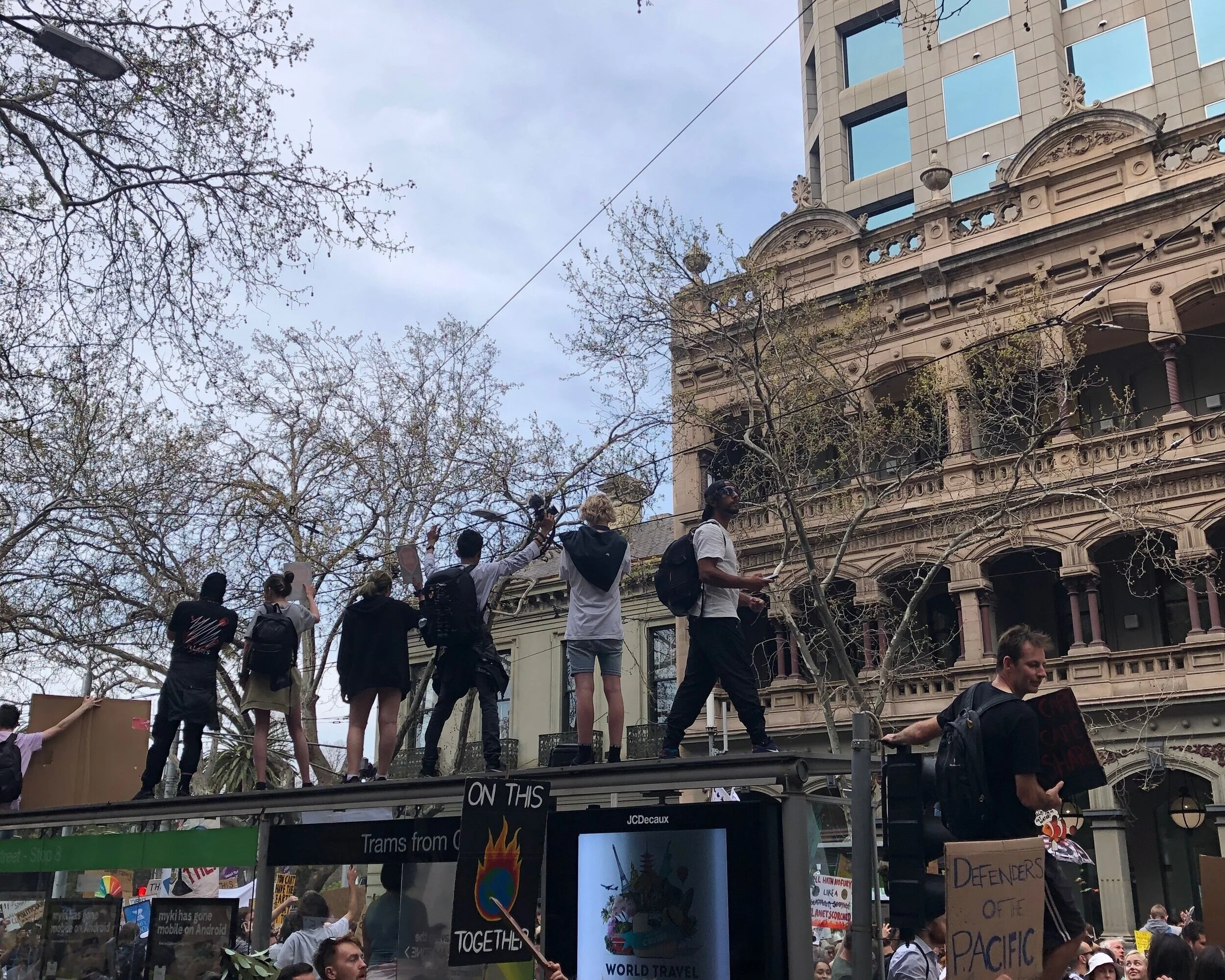 Young protestors atop tram stations. Photograph by Coral Huckstep