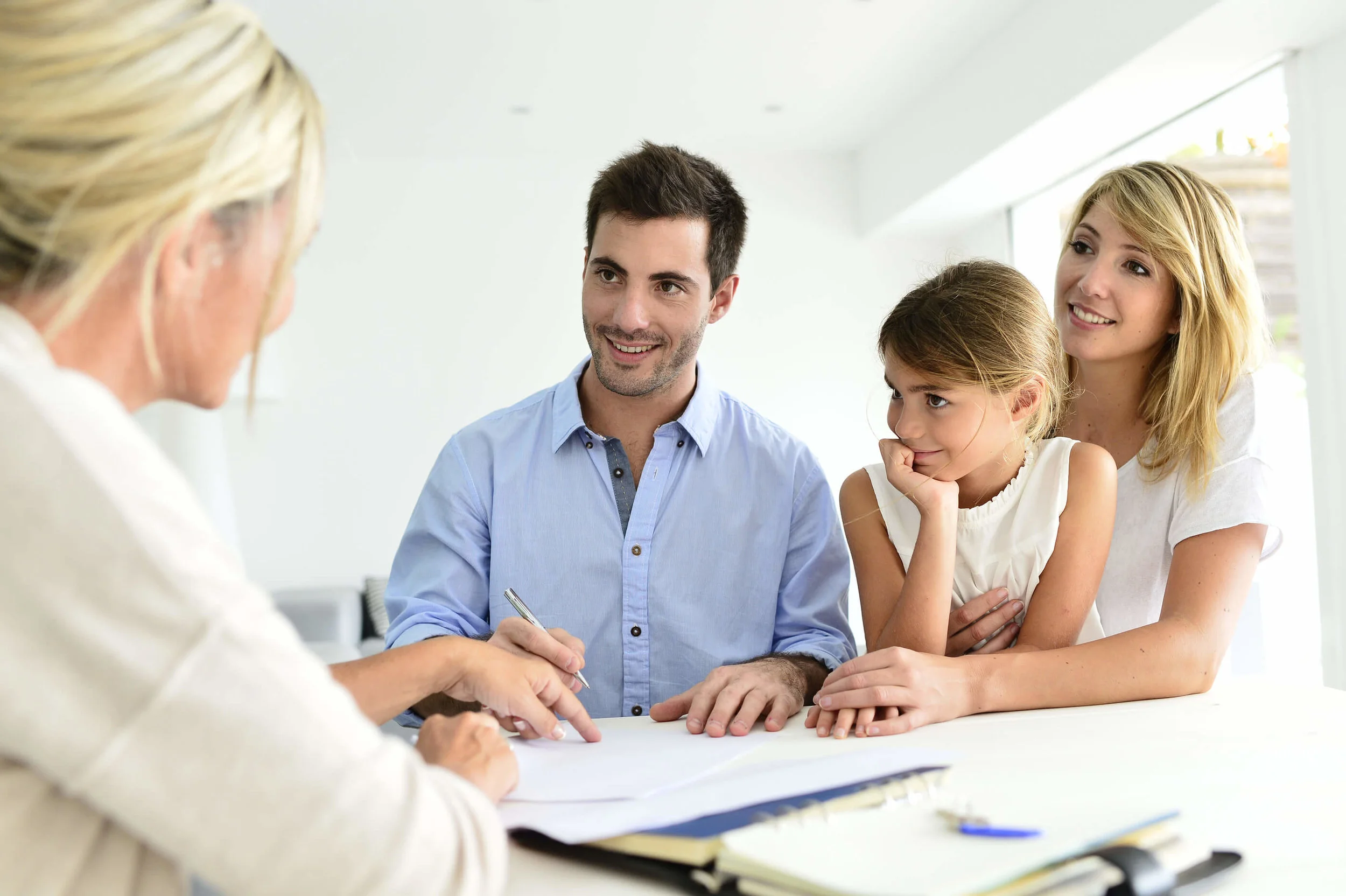 A young family at a table in a meeting with a business woman