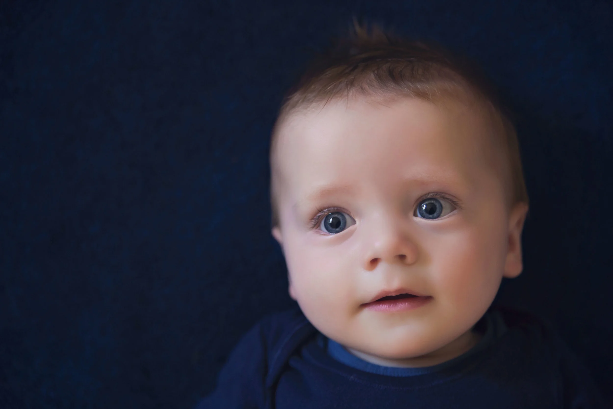 The sweetest baby boy in blue on blue carpet by Alina Owen