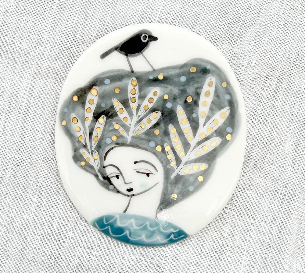 figure with golden leaves brooch.jpg