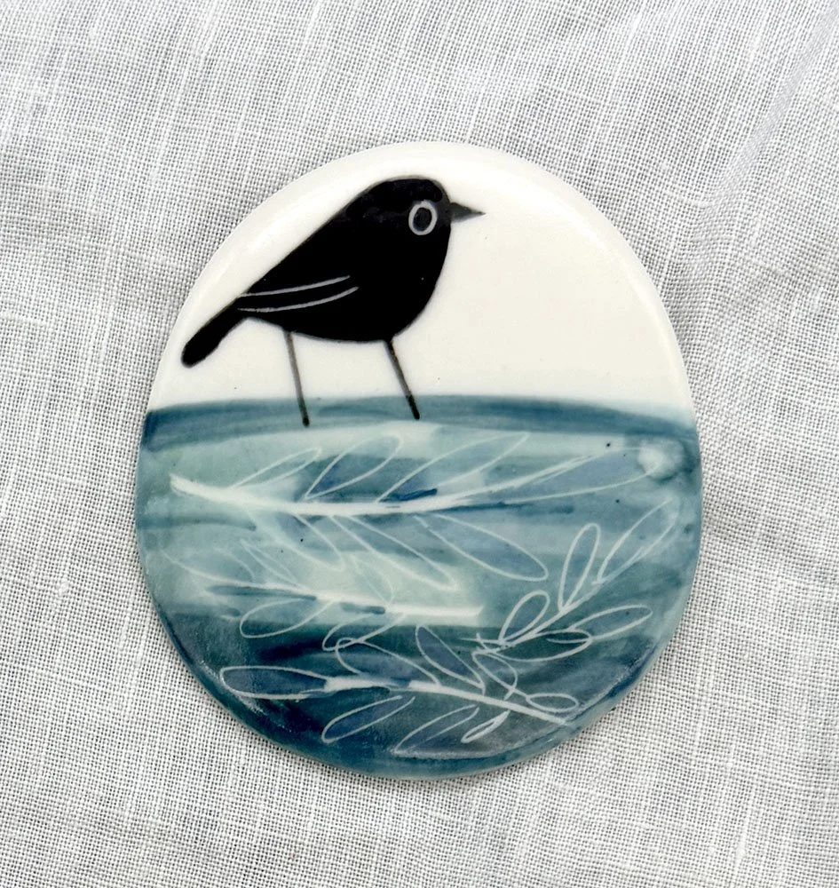 Brooch bird on blue.jpg