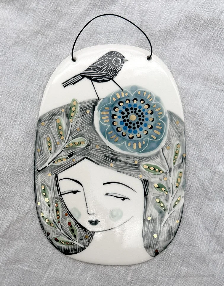 lady with bird ad blue flower.jpg