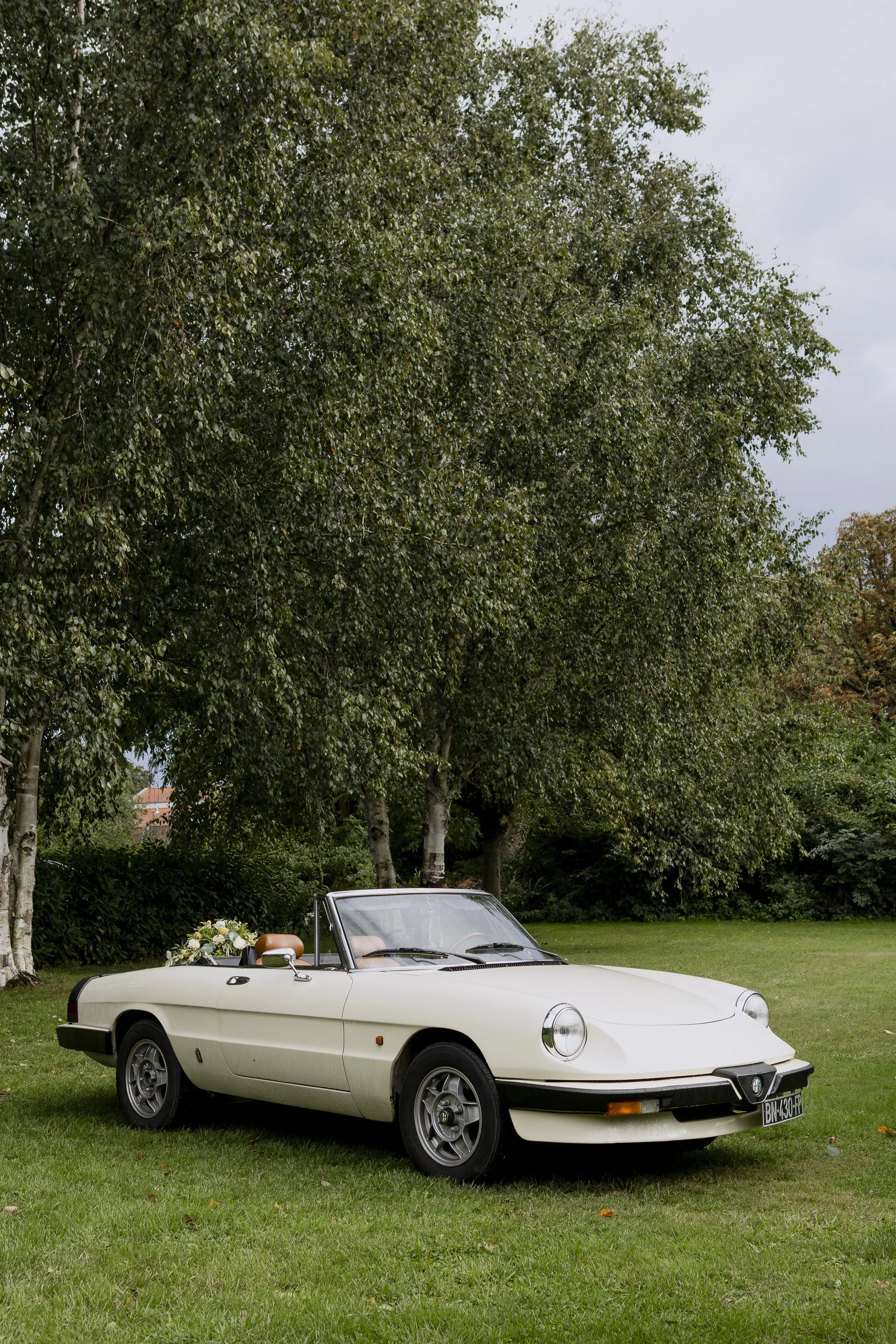 Voiture ancienne des mariés garée dans les jardins du Clos de la Source