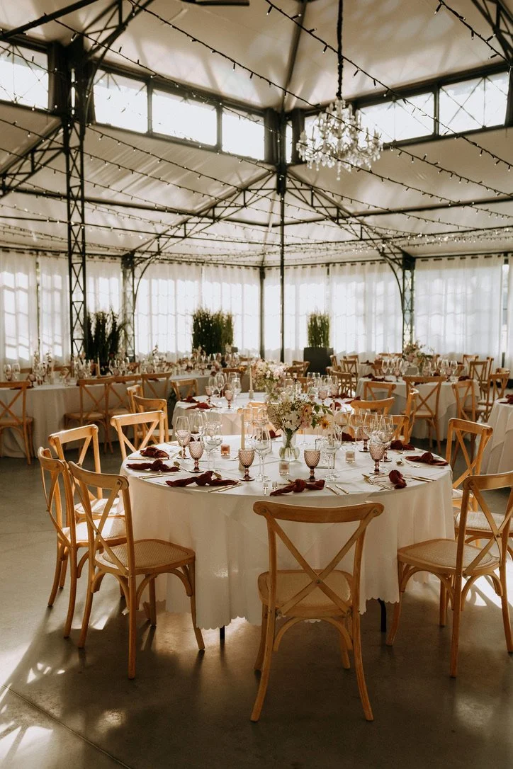 Tables rondes dressées pour un mariage sous l’Orangerie du Clos Barthélemy