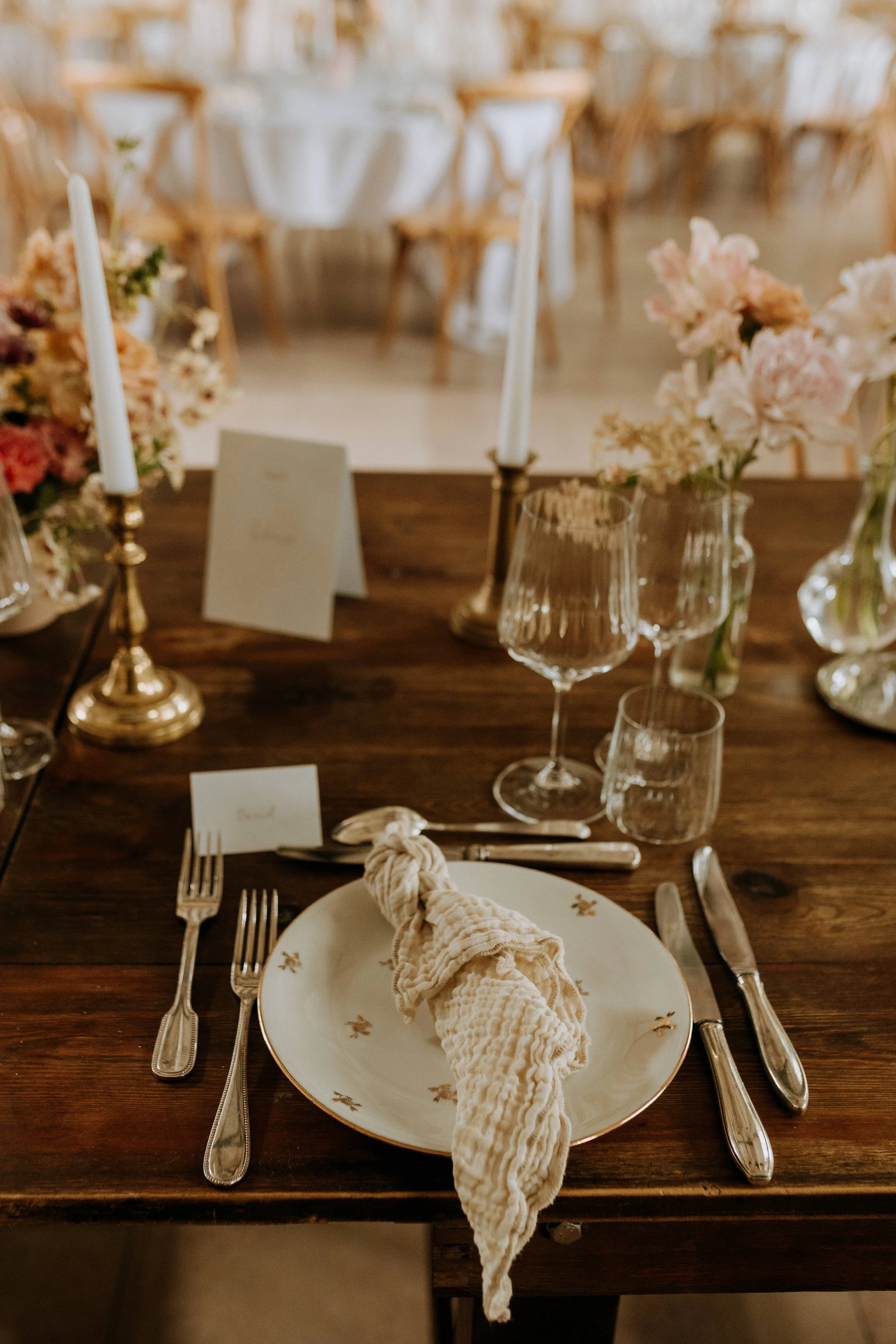 Détail d’une table de mariage, verres et chandelier doré, au Domaine d’Achelles