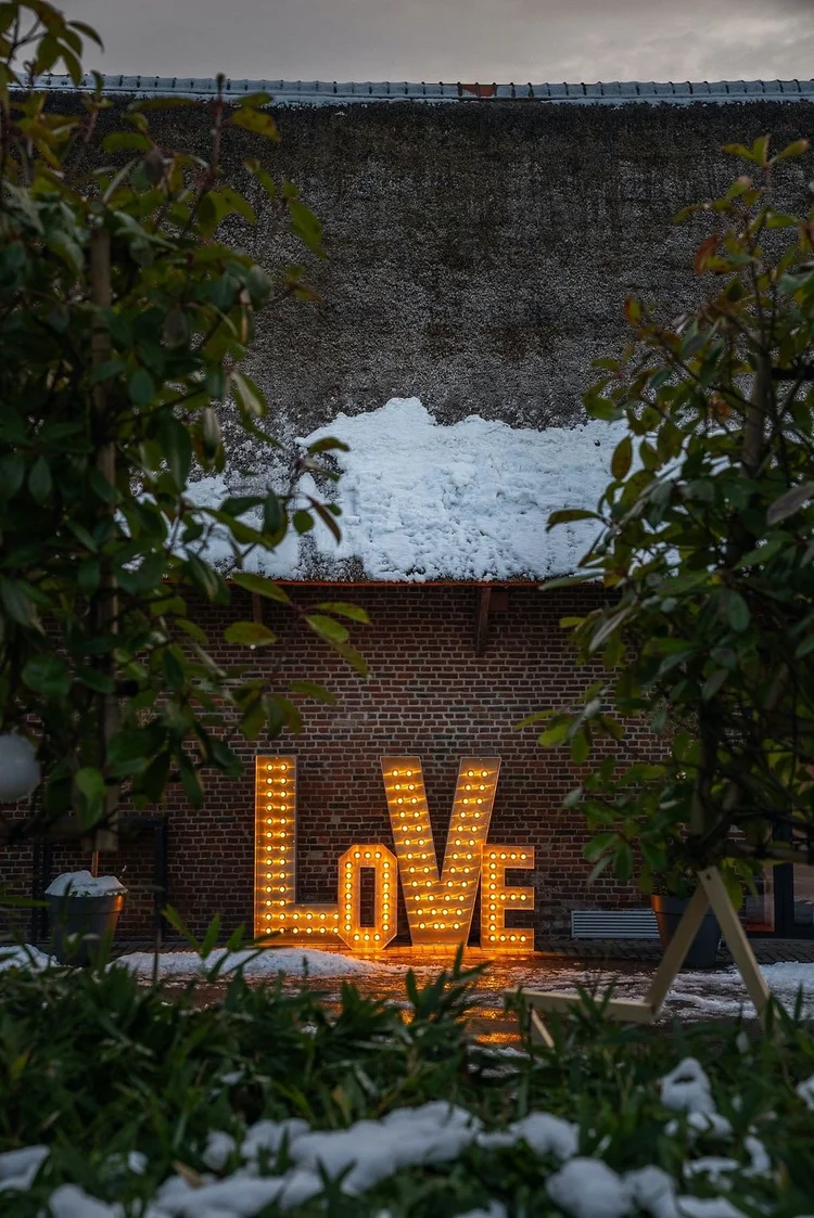 Destination Amour 2025 : lettres lumineuses LOVE dans la cour enneigée du Clos de la Source