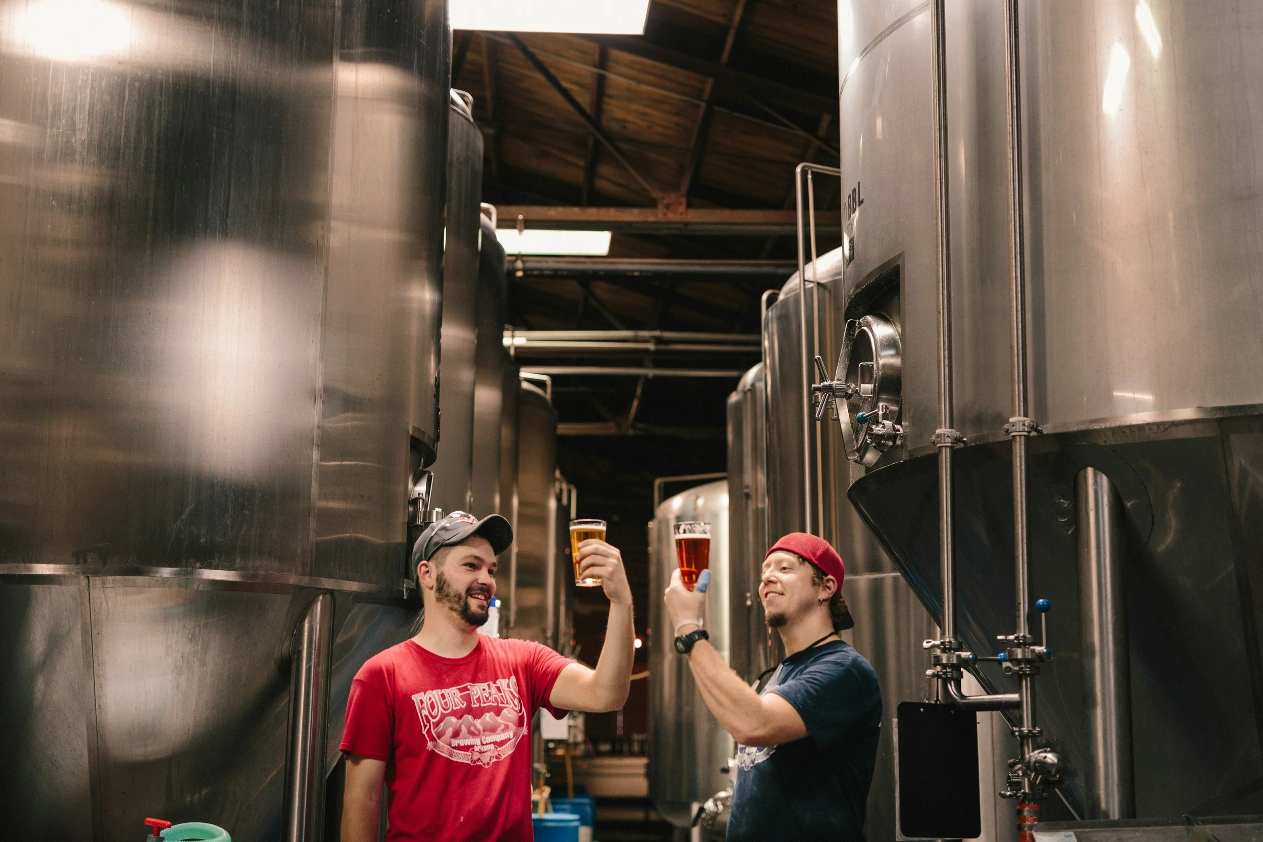 Two brewers inspecting beer made in a brewery