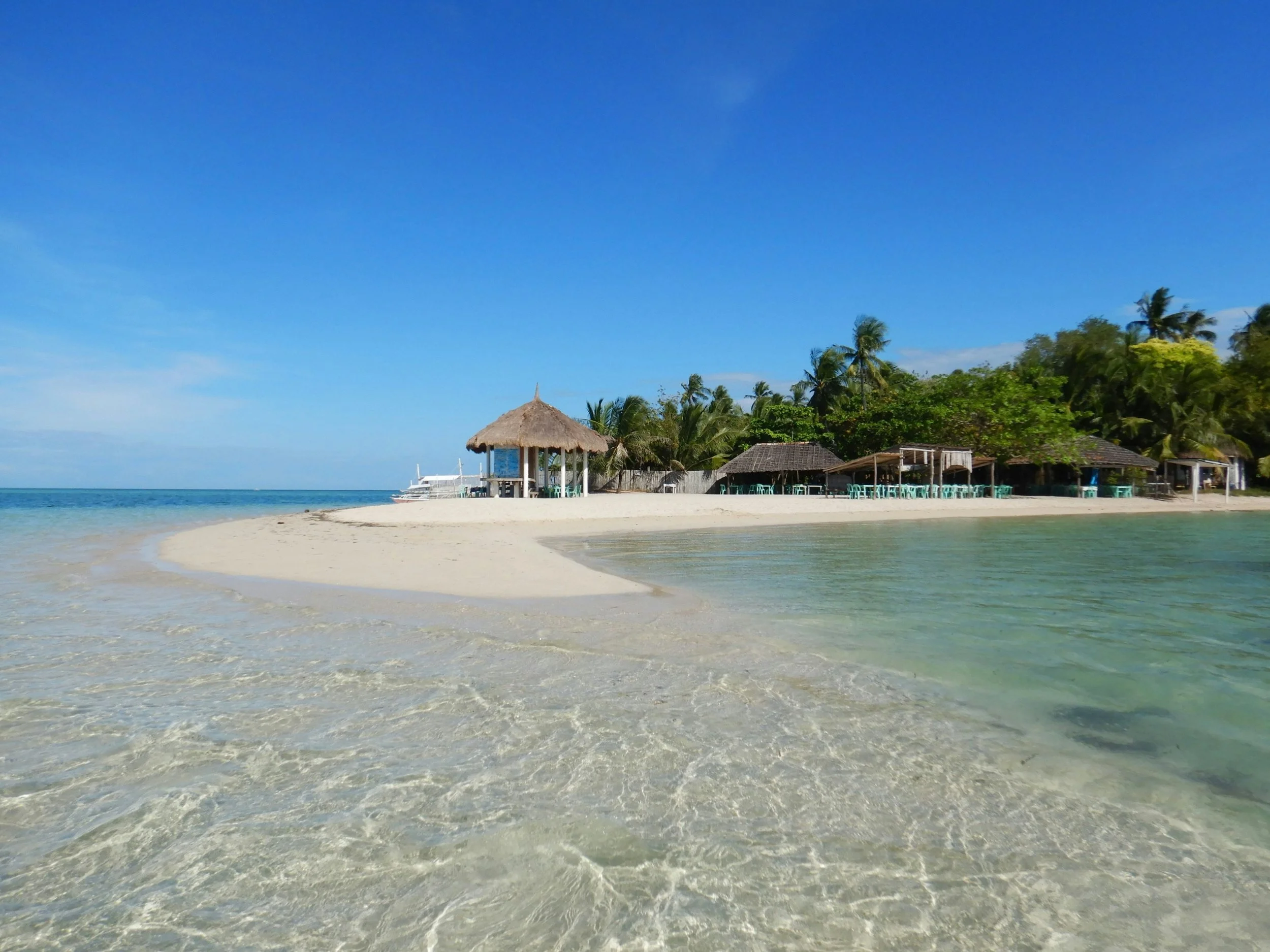 Beach photo with sand bar and tiki hut