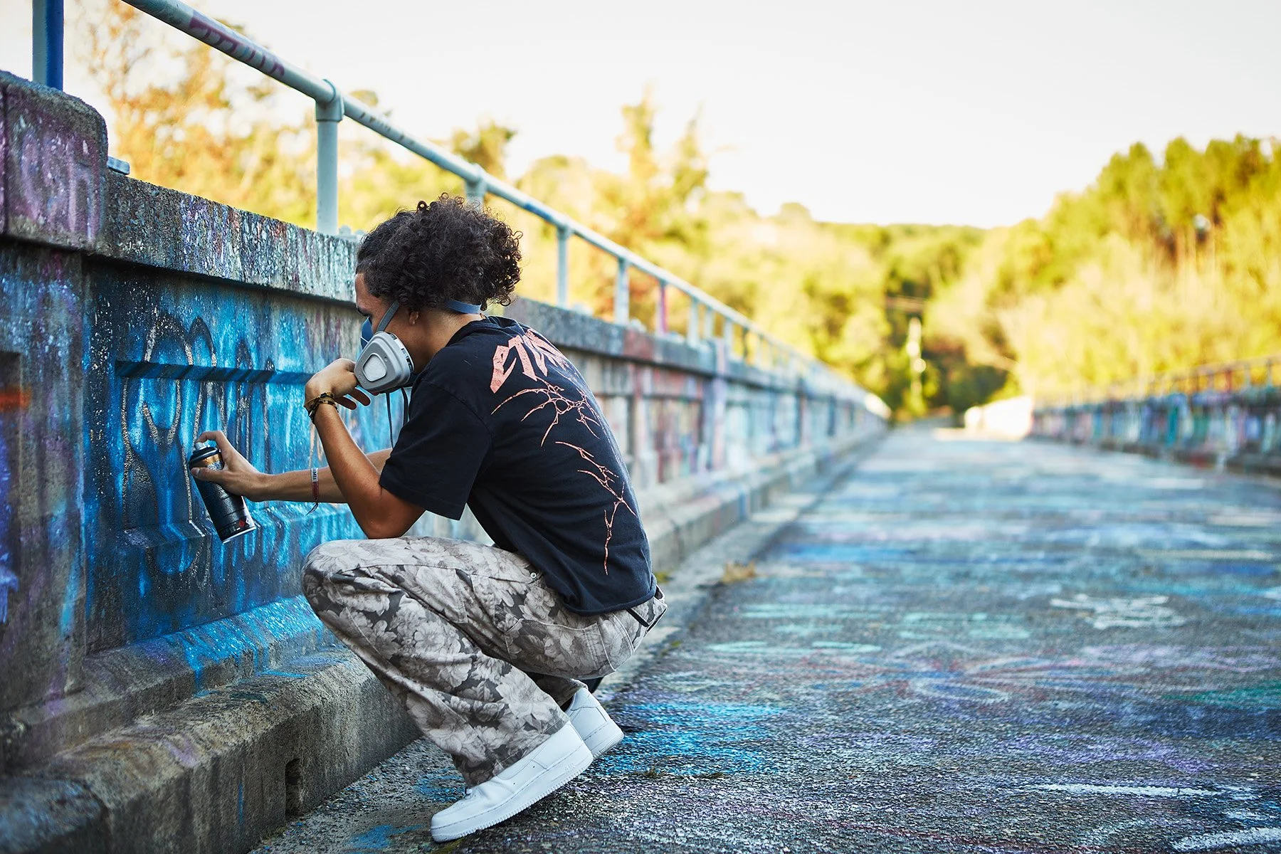  Graffiti artist SXW paints on the “open wall” of Bynum Bridge in Bynum, NC.  