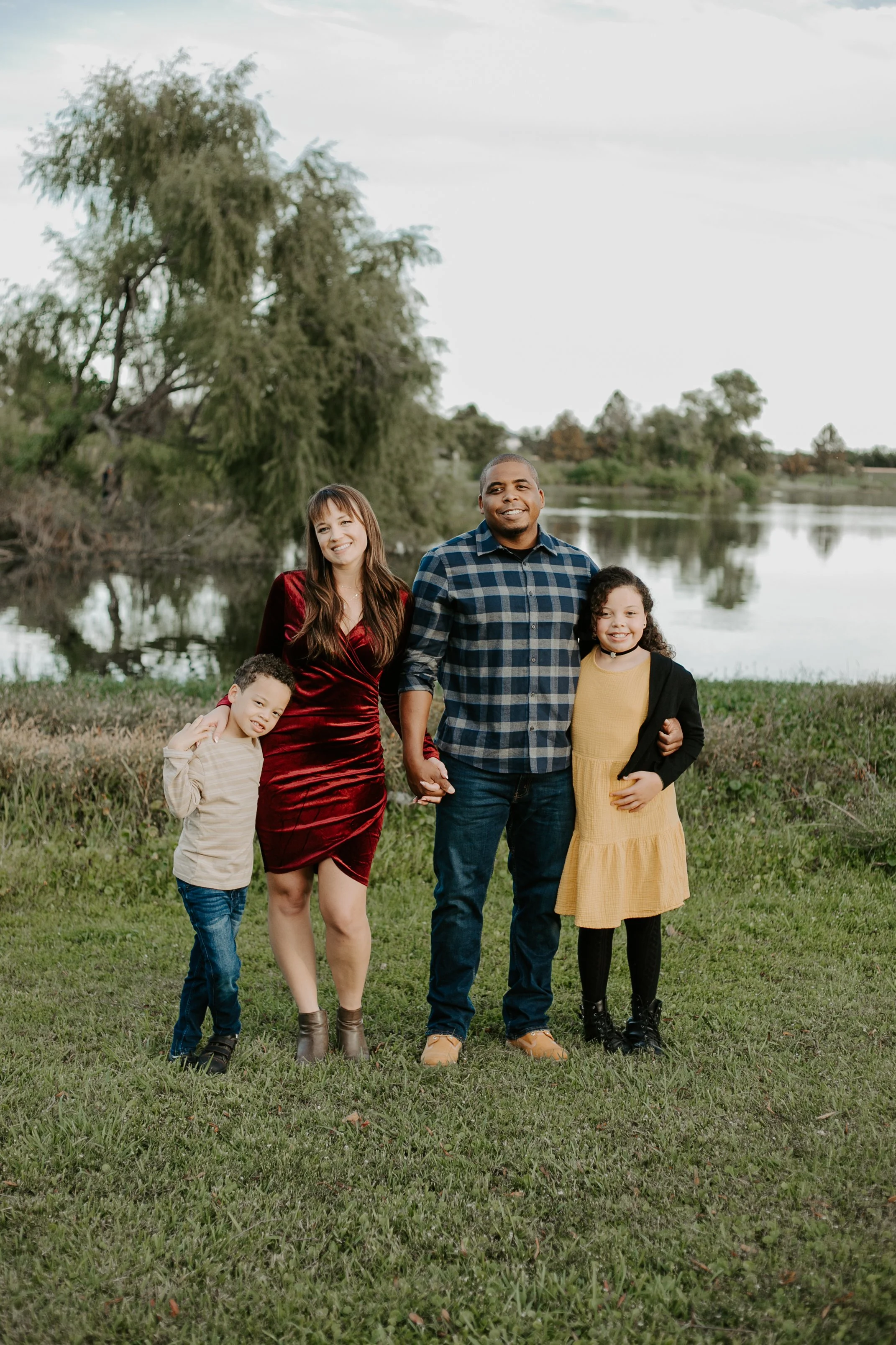 family of four standing by pond by Jessie Shaw Photo