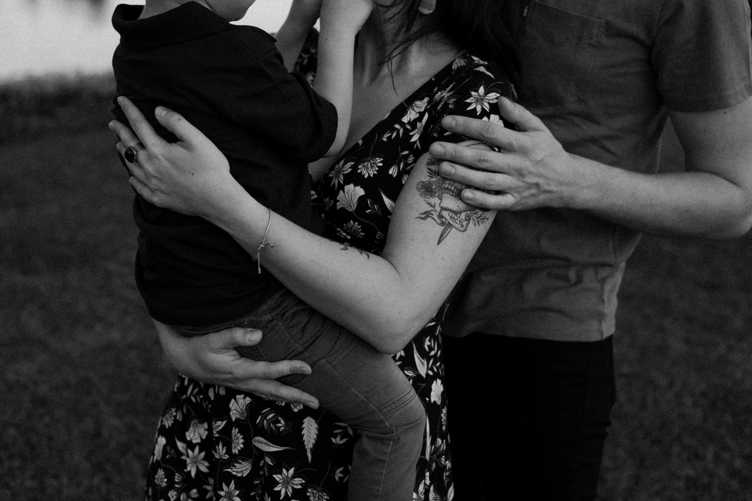parents hold their toddler in their arms by Austin family photographer