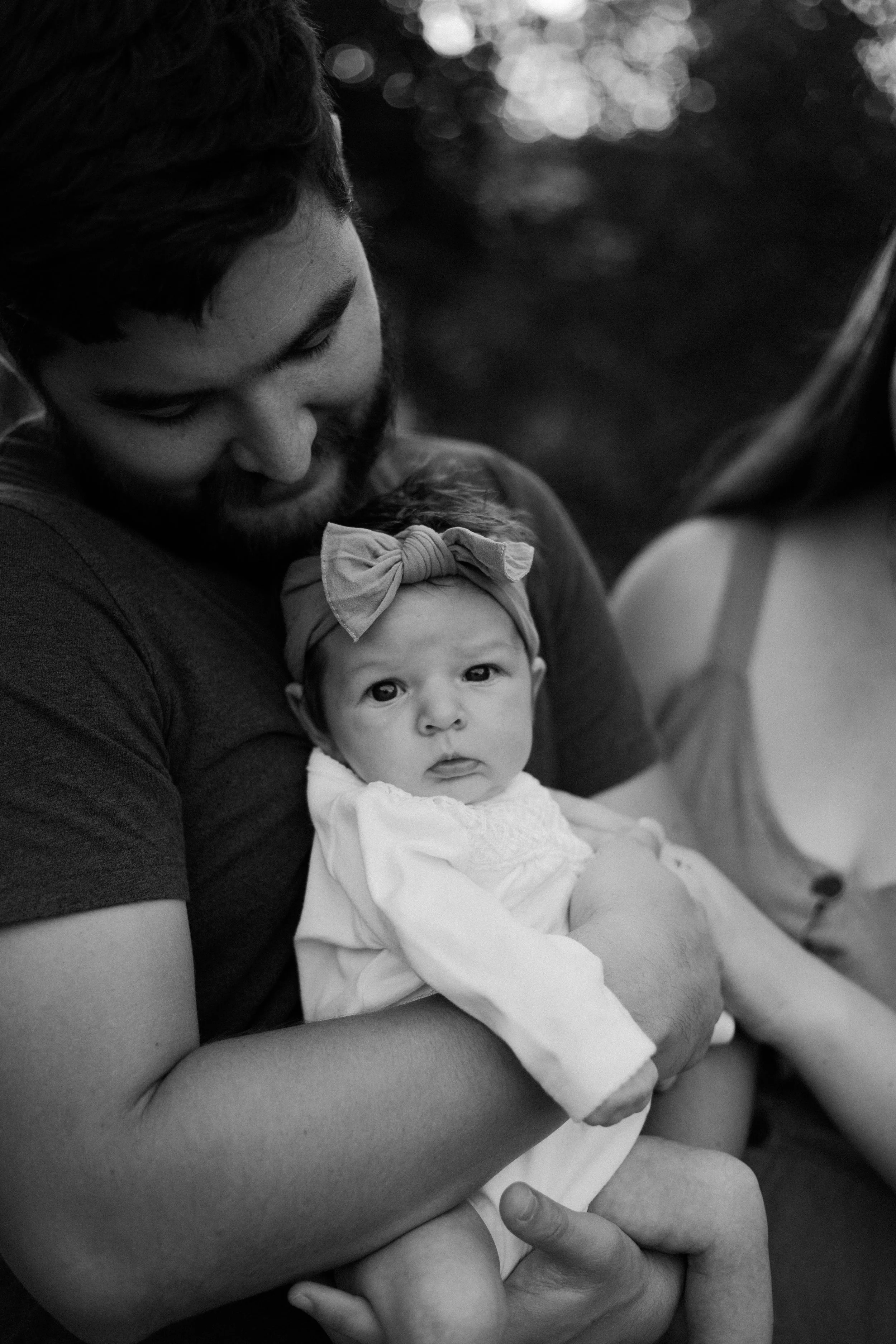new parents snuggle daughter close by Jessie Shaw photo