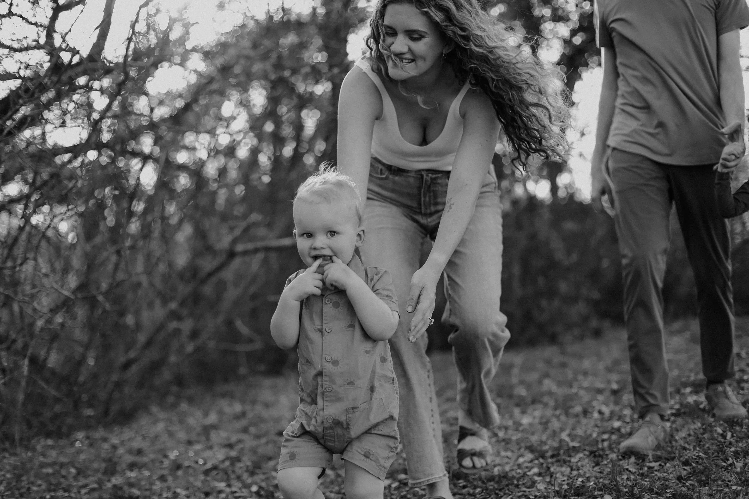 mom chasing her toddler through park by Austin family photographer