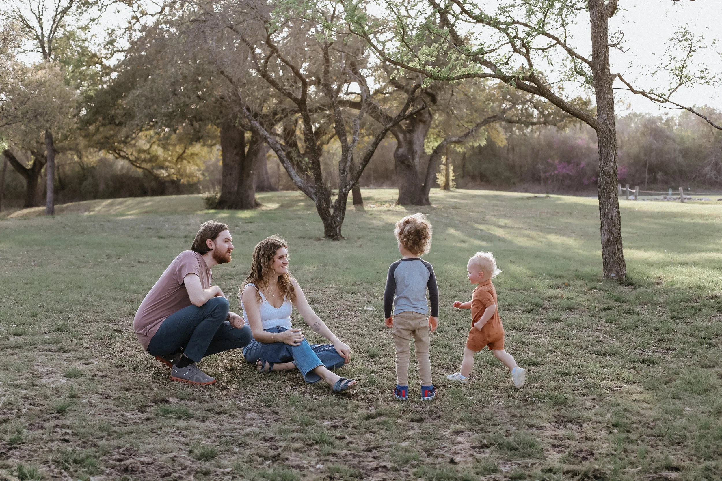 family plays games on lawn during golden hour for mini sessions