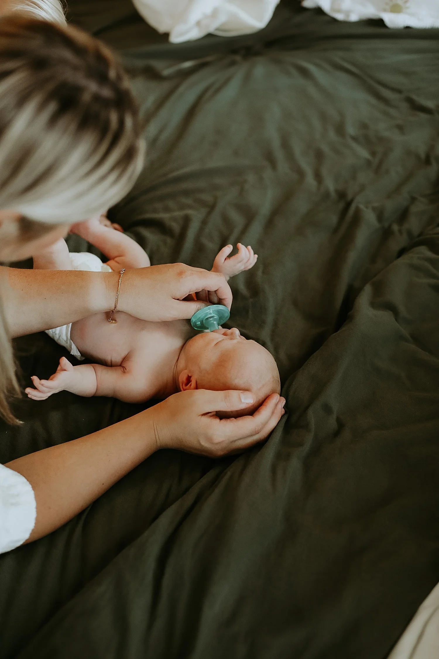 woman offers paci to her tiny son by Austin family photographer