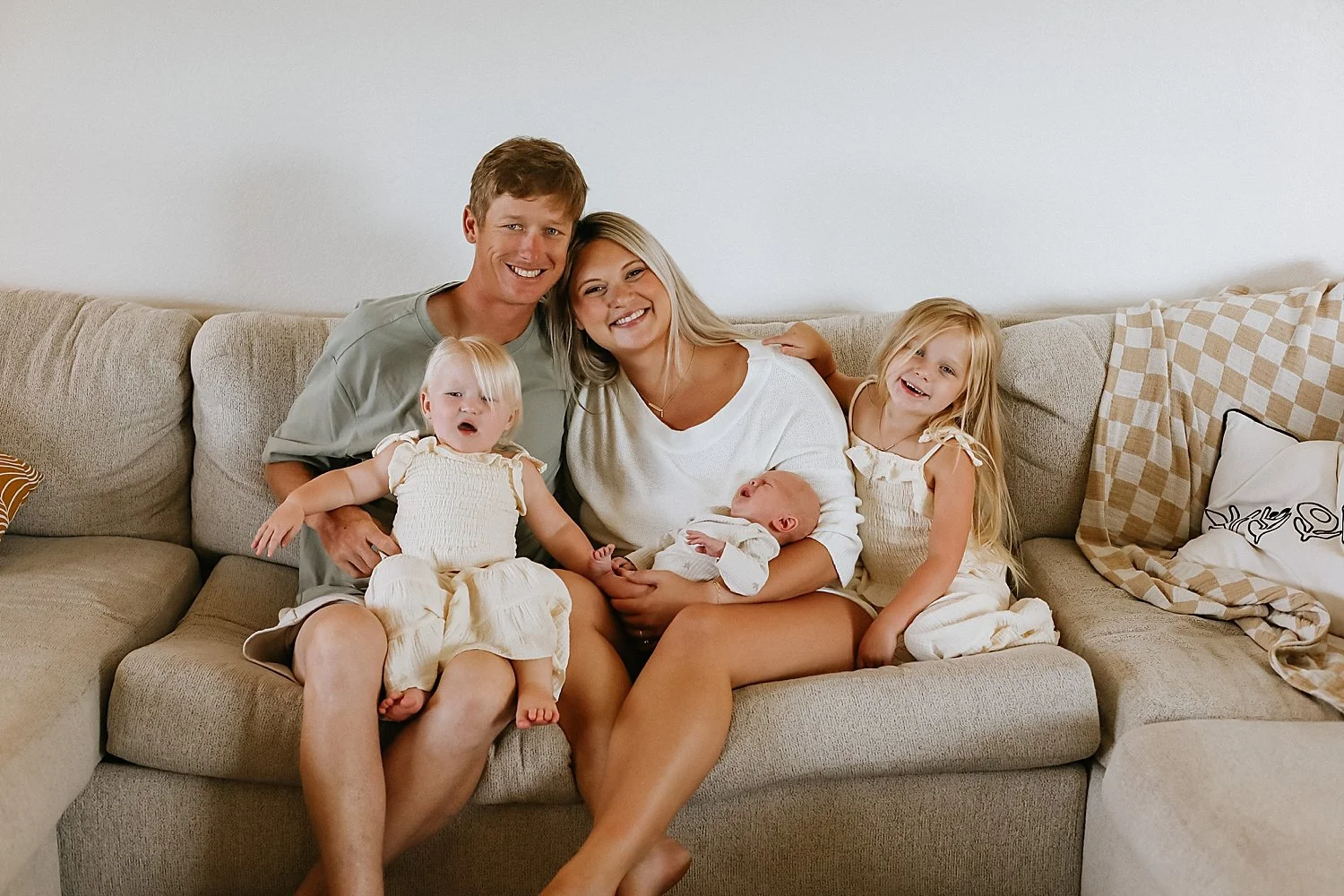 family of five smiles together on the couch by Jessie Shaw photo