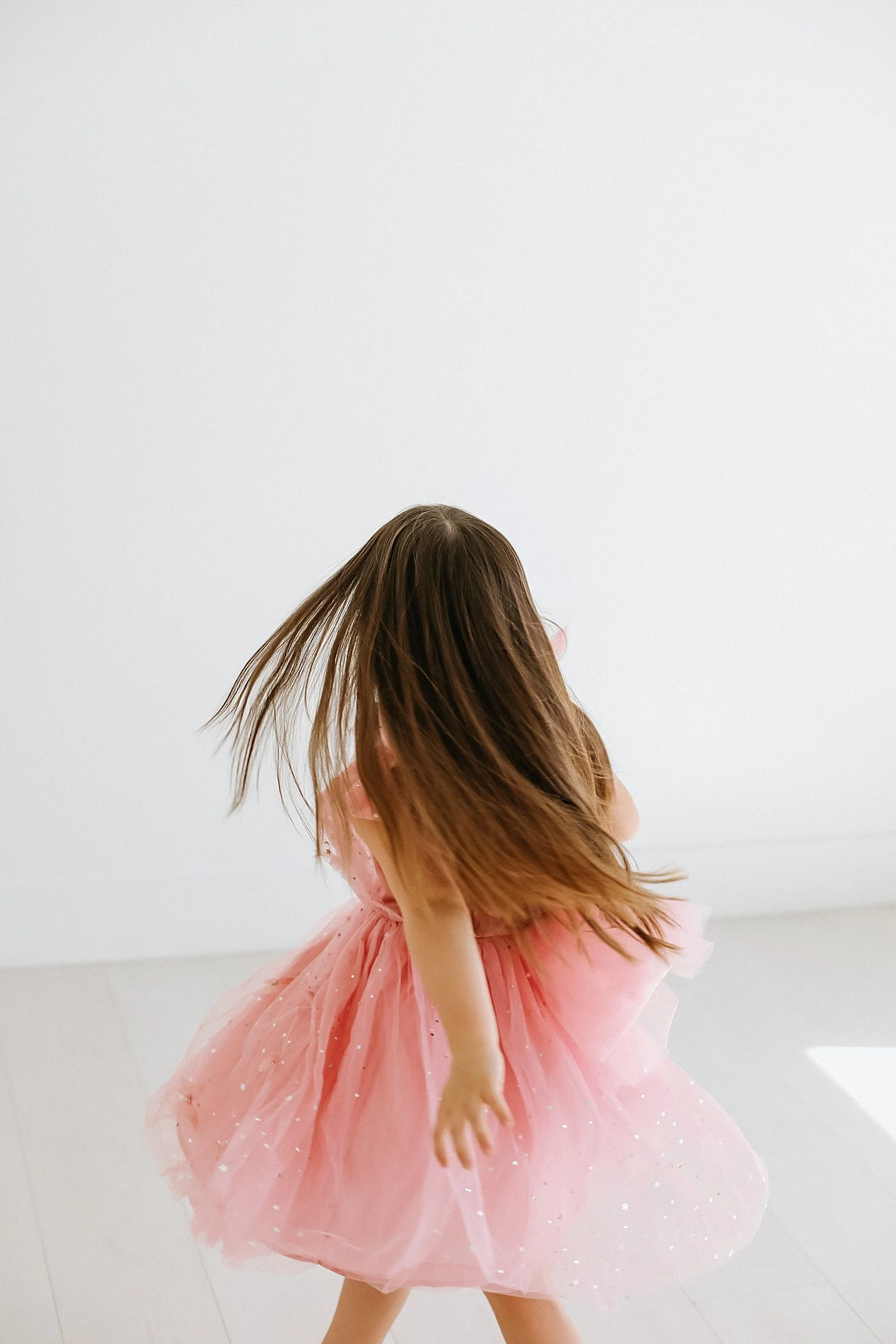  little girl spins in studio by Austin Family Photographer 