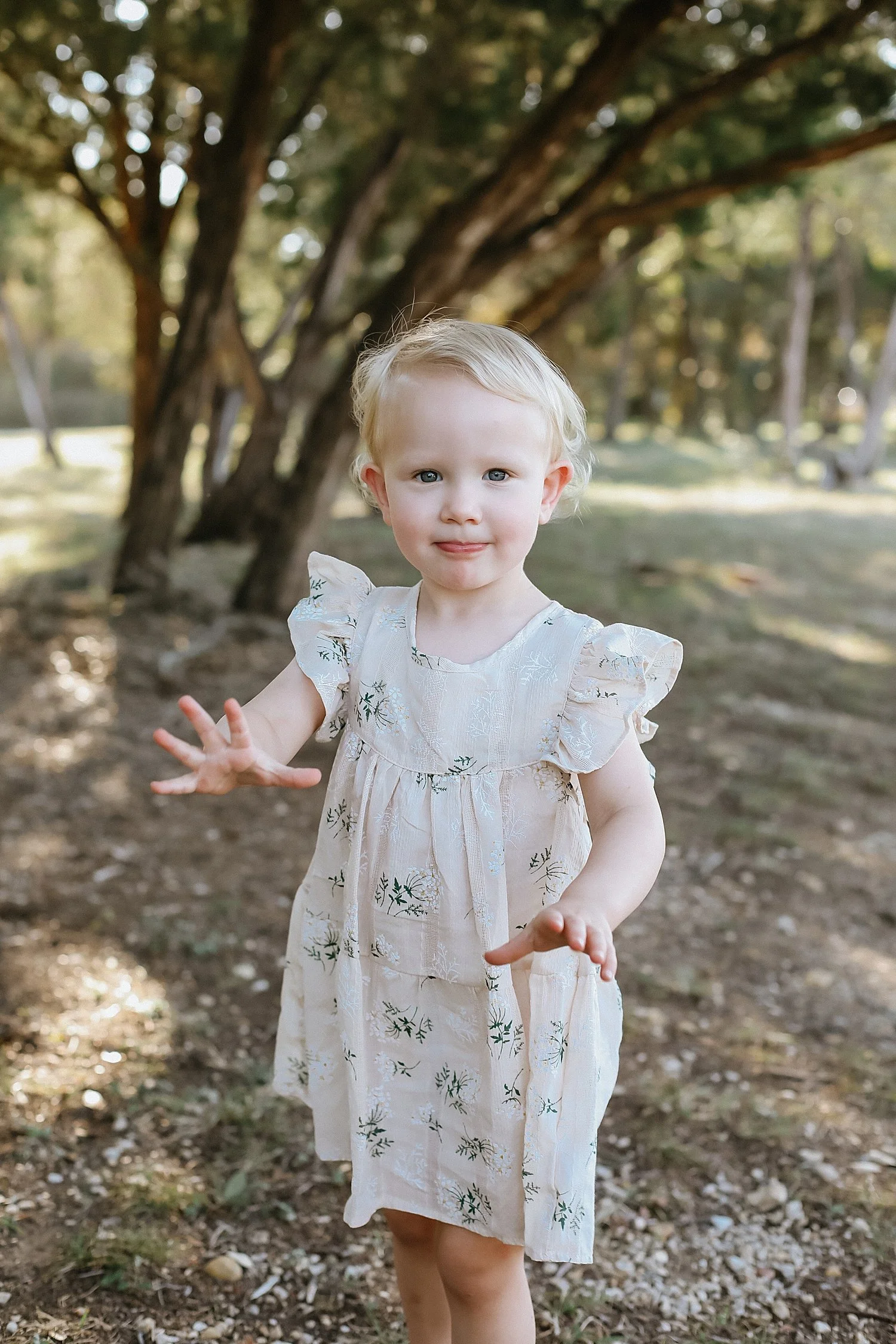  toddler in floral dress outside by Jessie Shaw Photo 