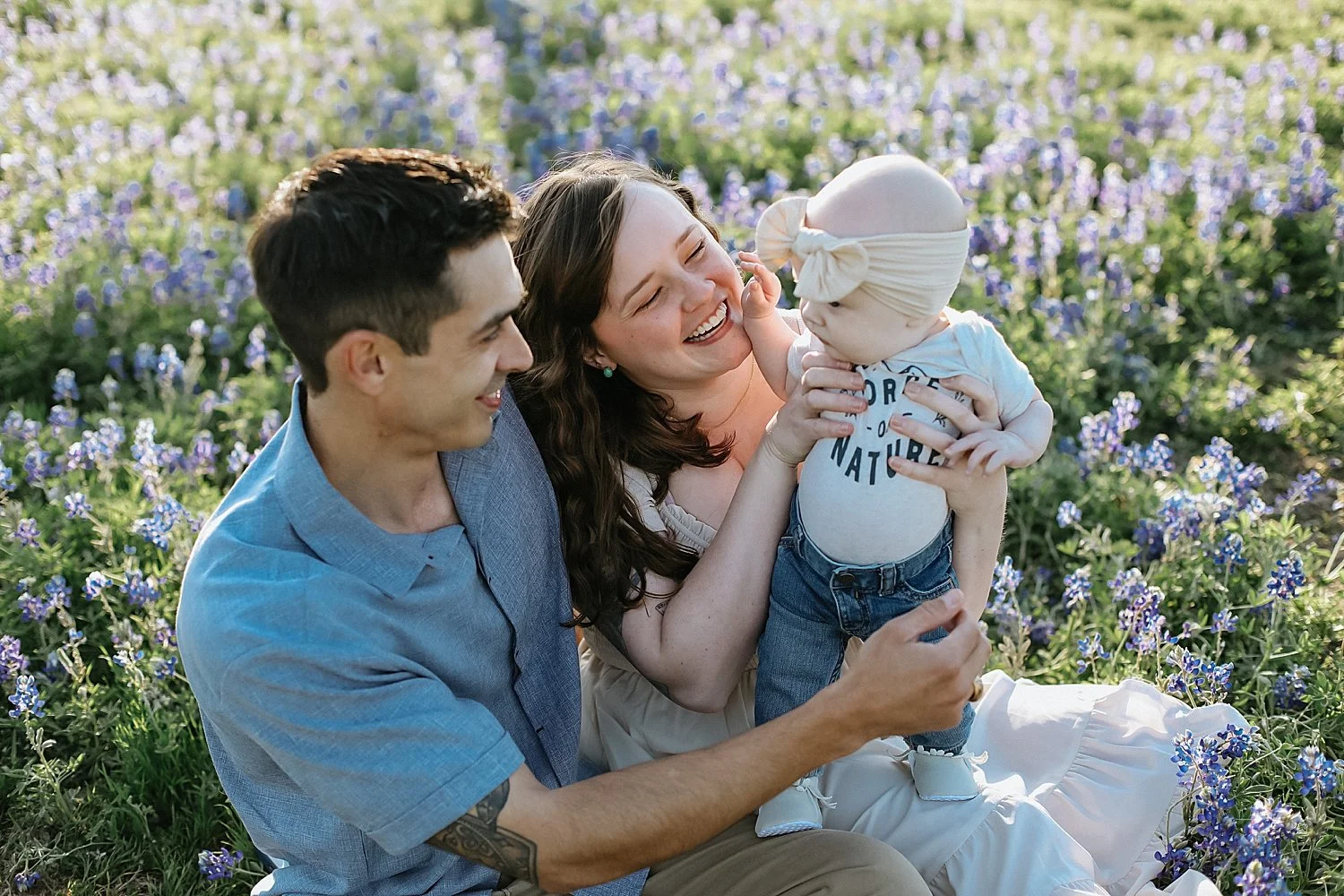  parents lean in to hold sweet babe in their lap by Jessie Shaw Photo 