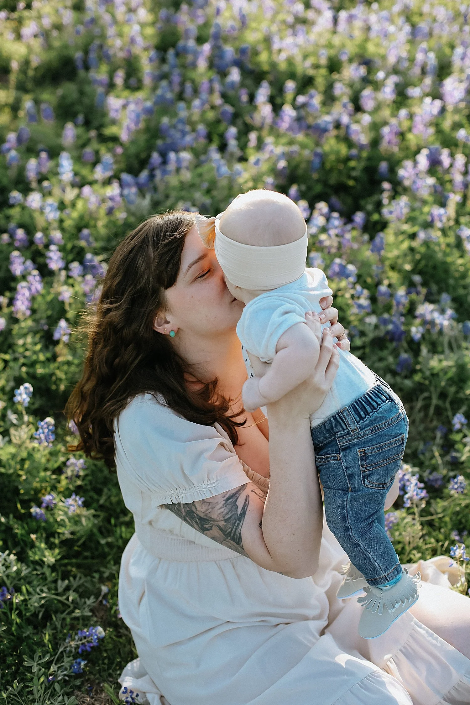  Mom lifting baby for kisses for Texas Bluebonnet photo session 