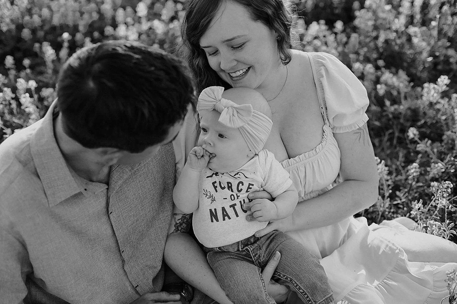  parents lean in, smiling over their babe, by Austin family photographer 