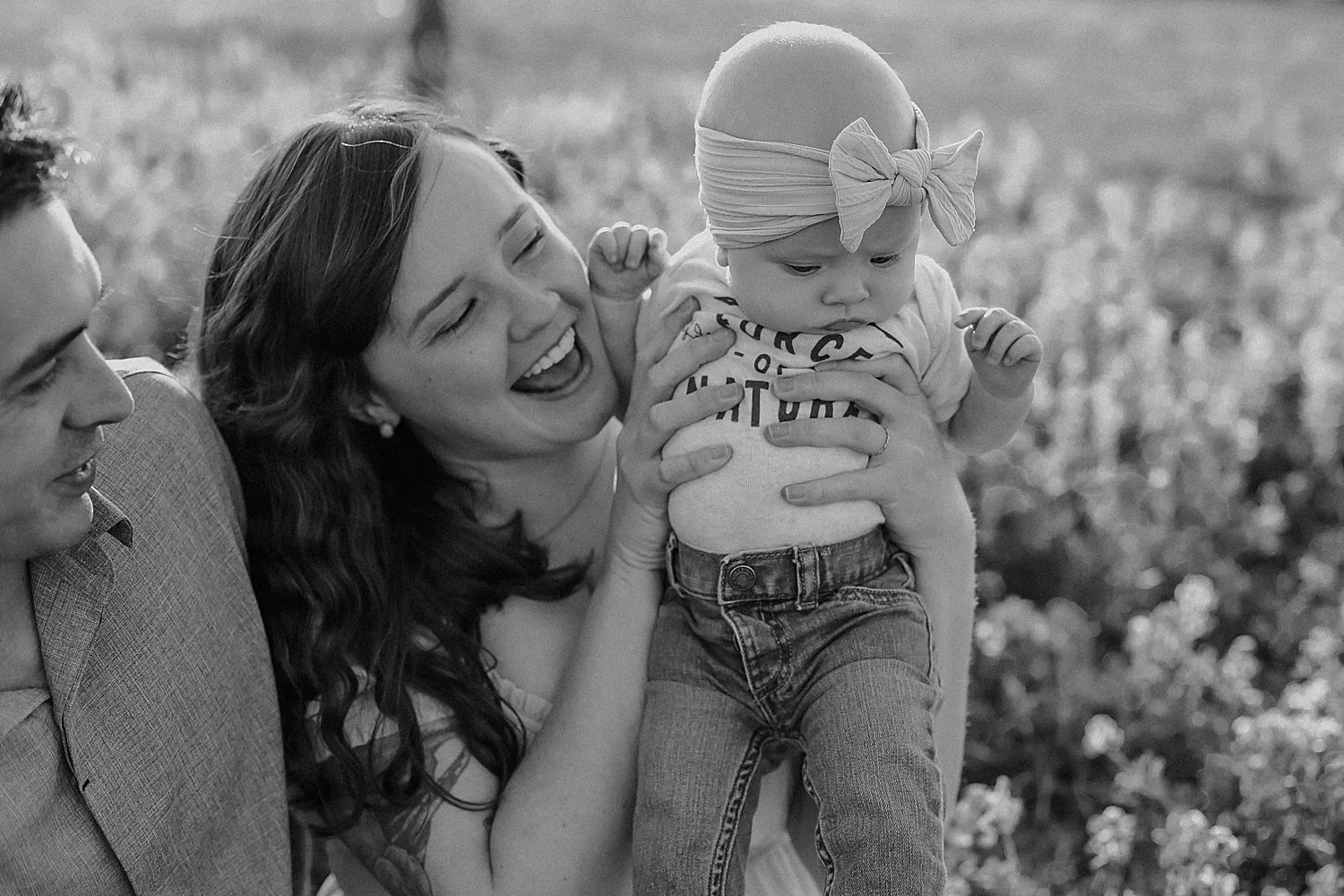  mom lifts up her 6 month old and smiles at her by Austin family photographer 