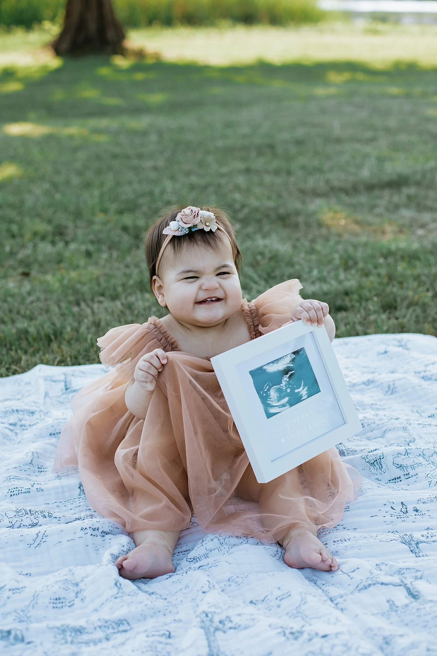  12 month old sits on blanket in the grass at park by Jessie Shaw Photo 