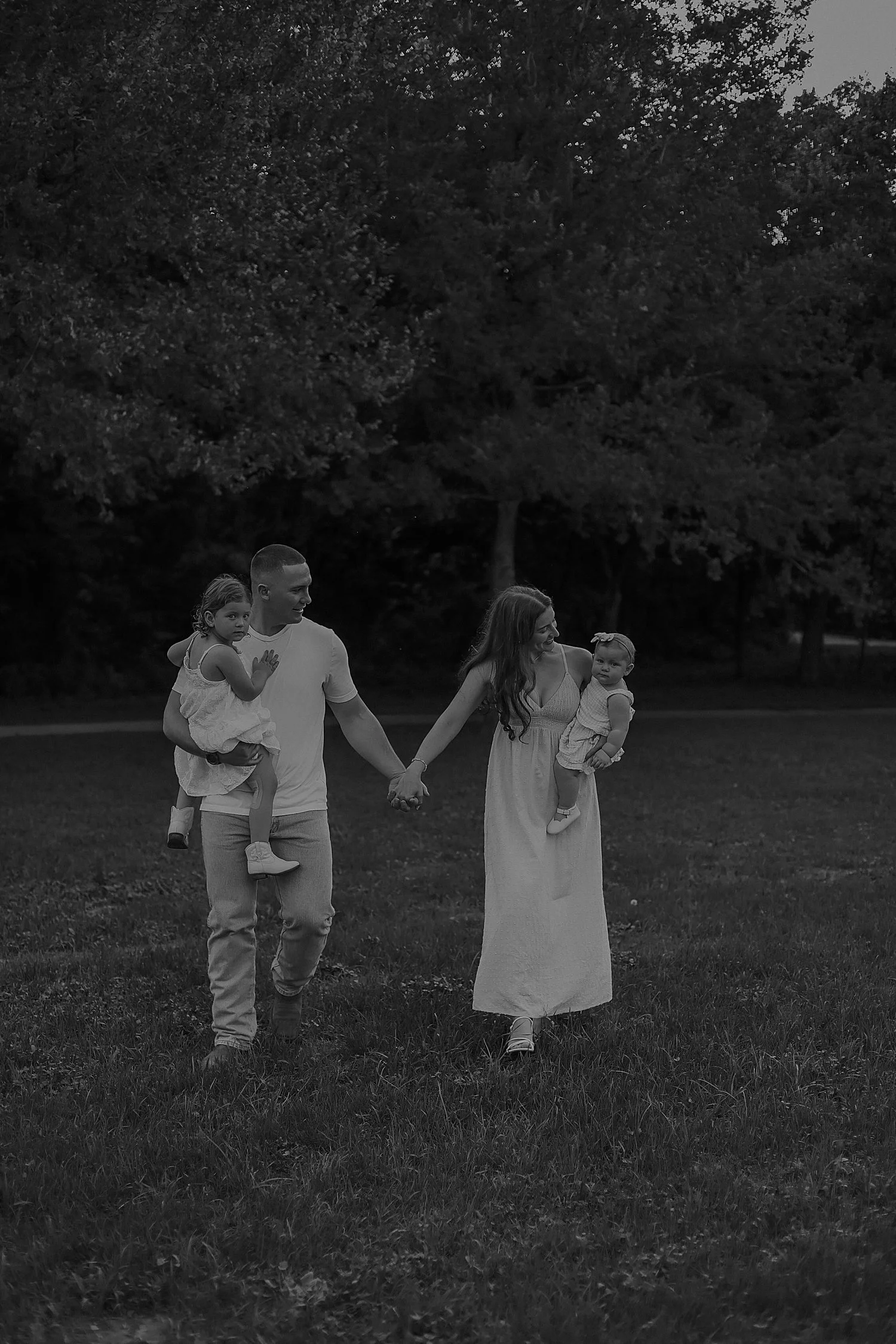  man and woman walk hand in hand with babies by Austin and Round Rock photographer 