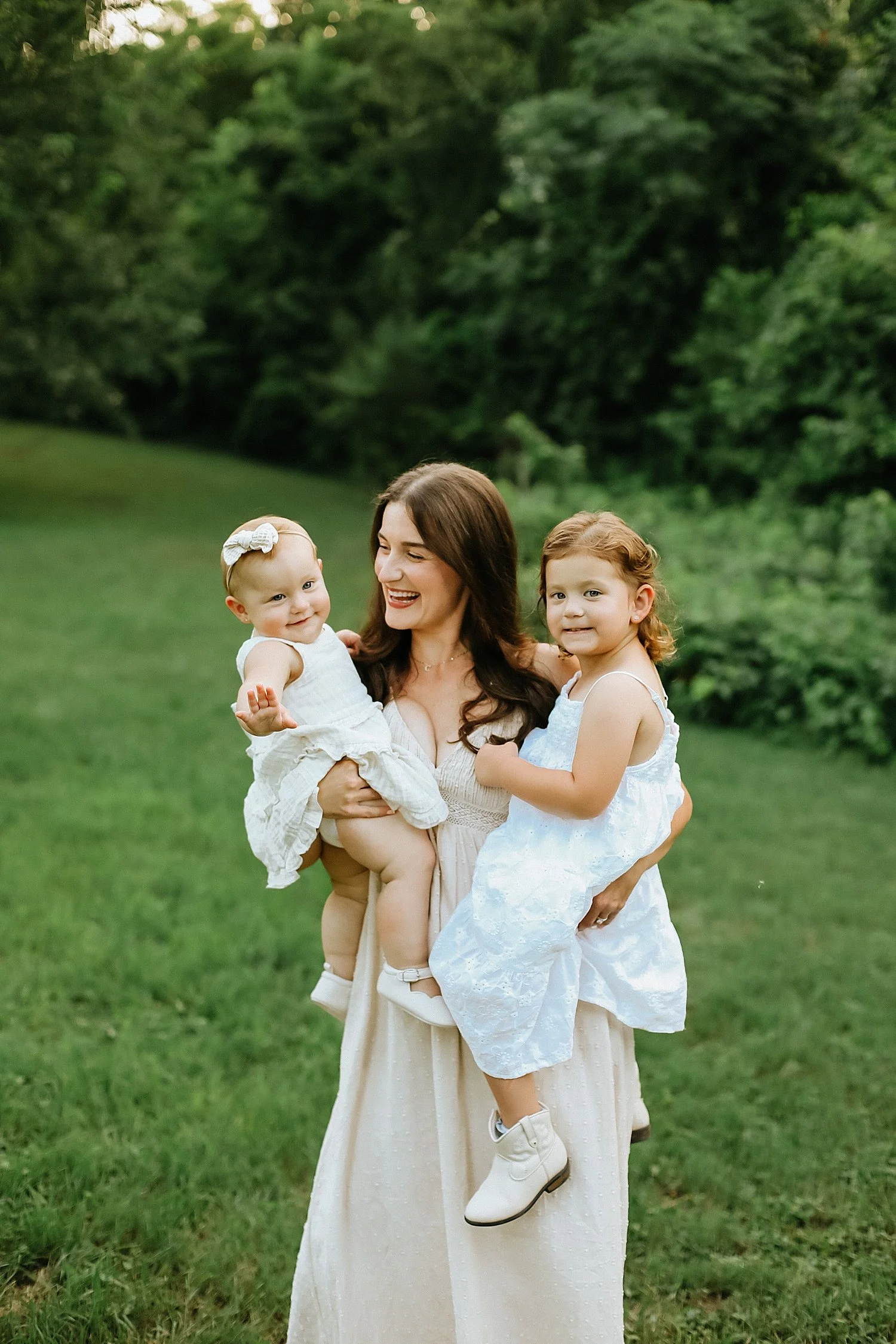  brunette mother holds two baby girls on hips by Austin and Round Rock photographer 