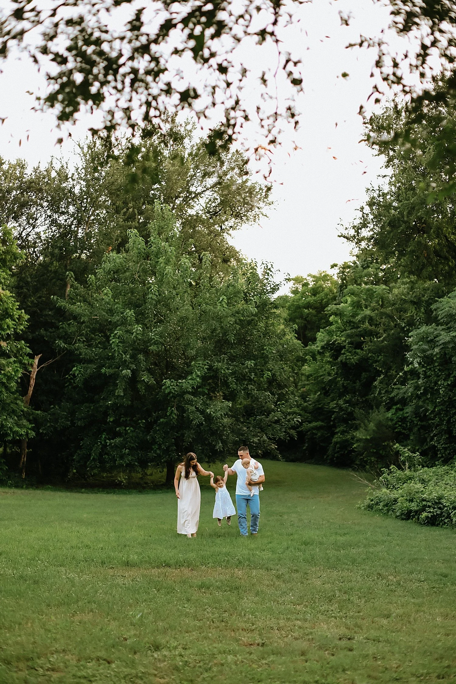  parents walk hand in hand with their toddlers by Austin and Round Rock photographer 