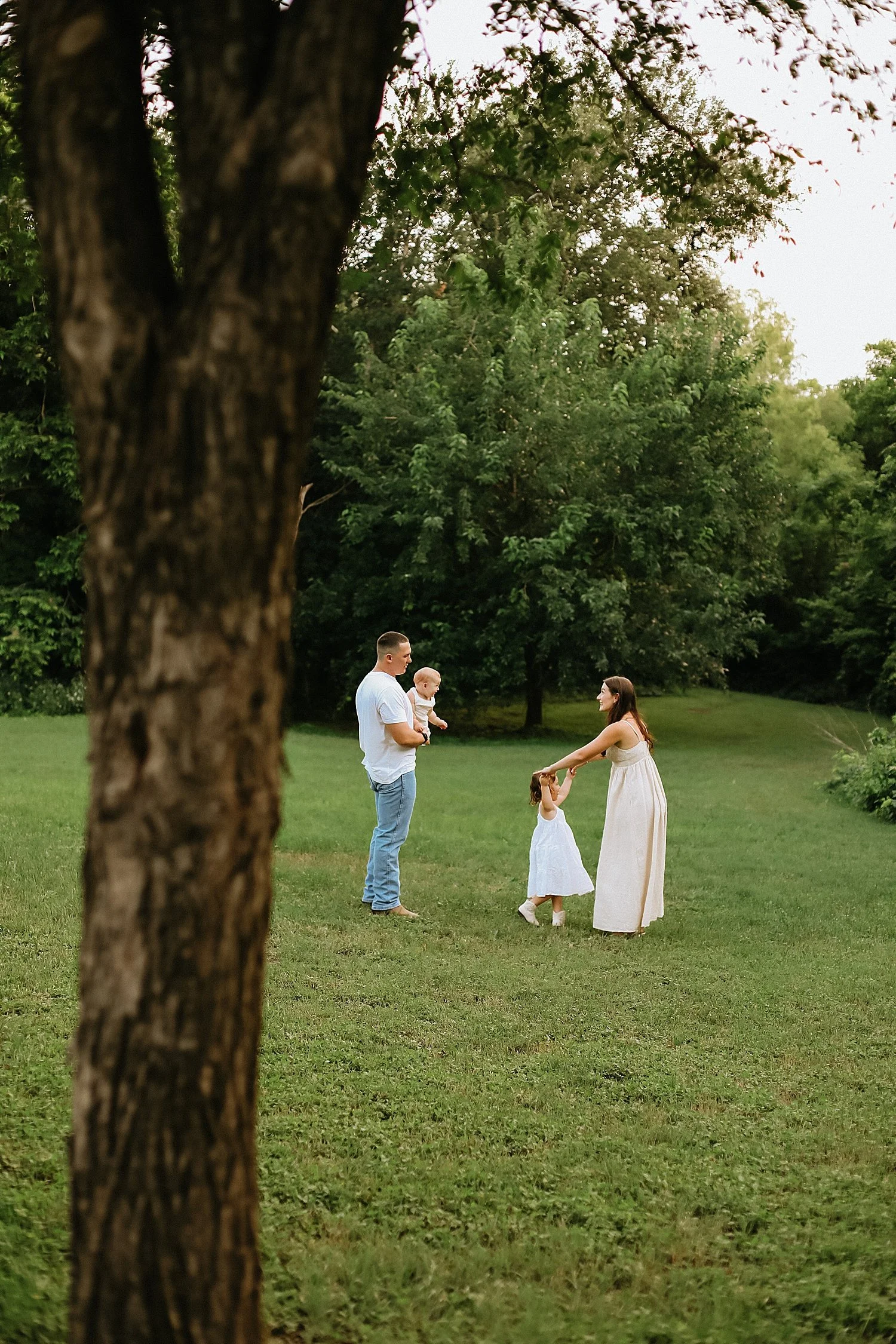  mom spins her little daughter in white dress by Jessie Shaw Photo 