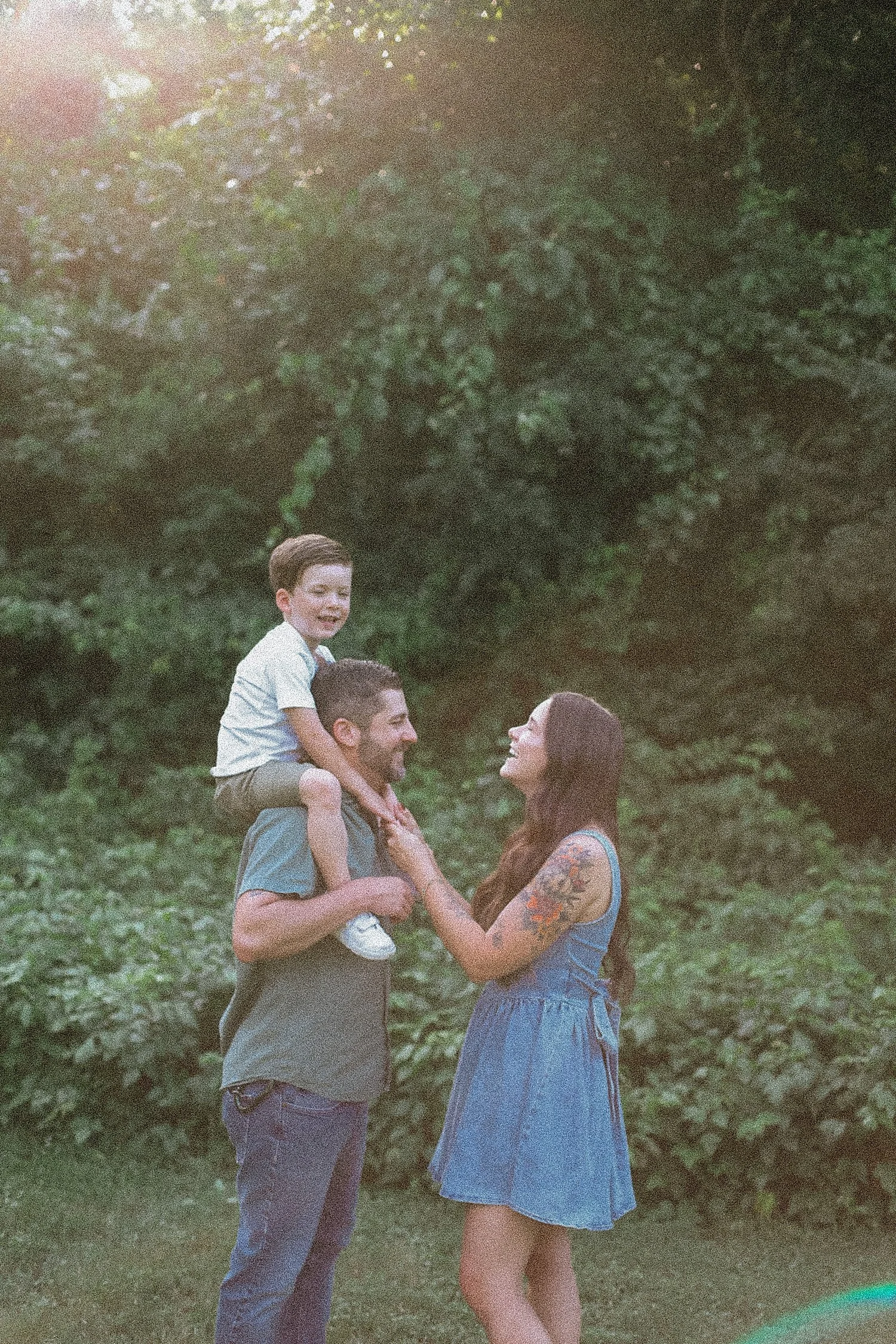  toddler sits on dads shoulders next to mom showing what to bring to your mini session 